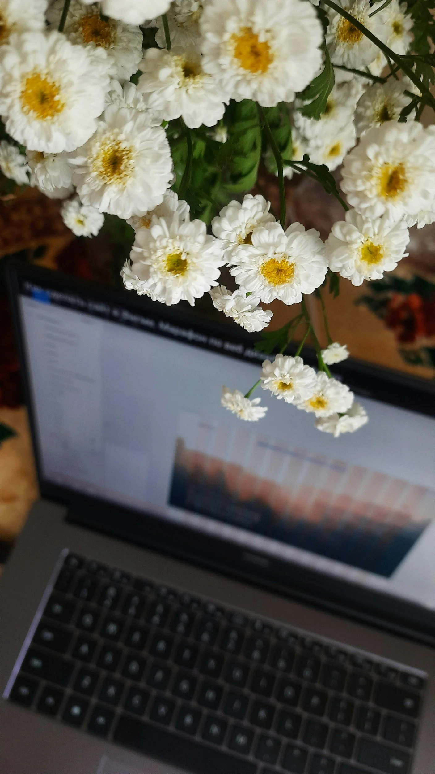 Virtual counseling with flowers hanging on top of laptop