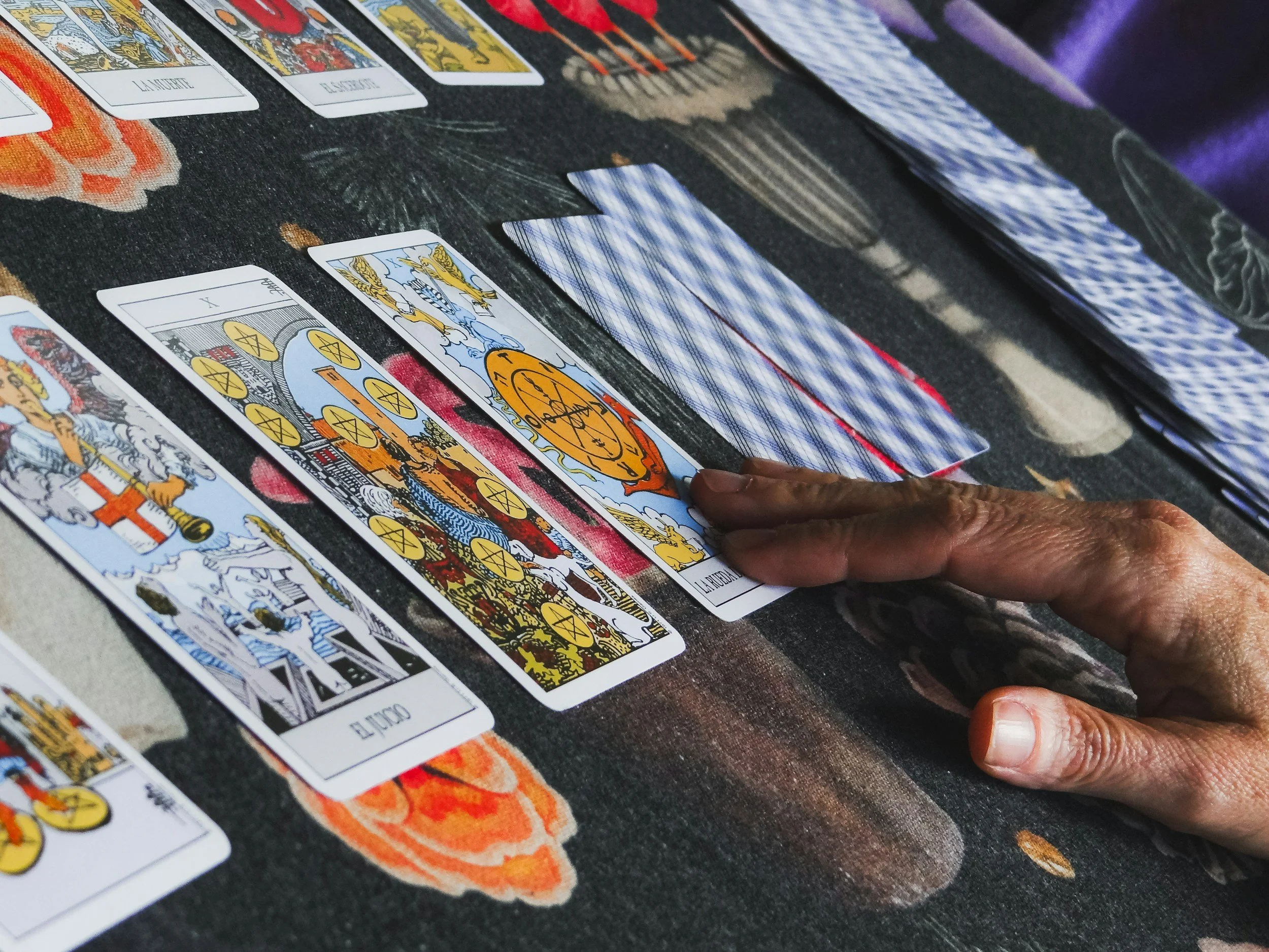 Black woman's hand touching tarot card for tarot reading