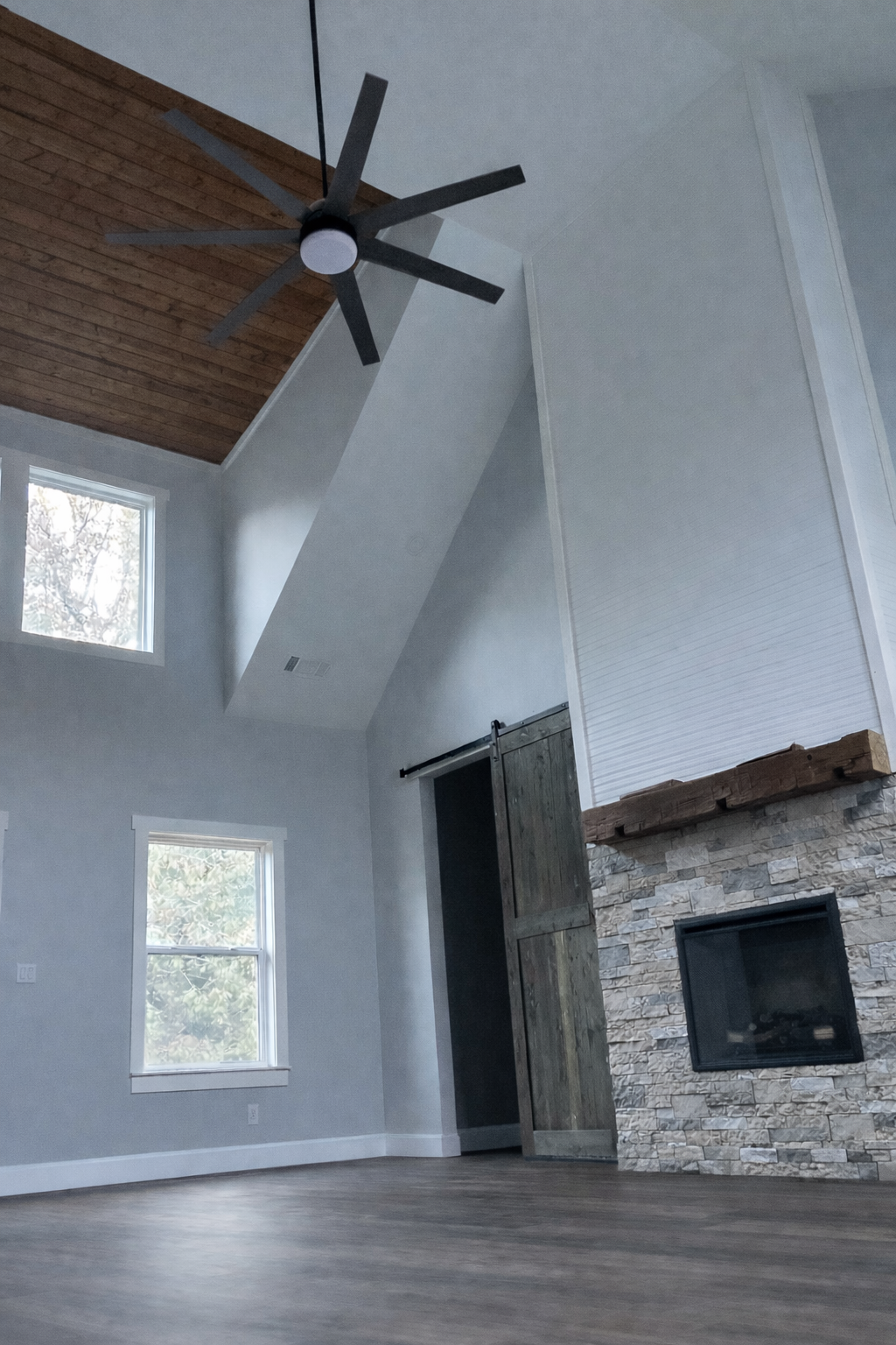 living room vaulted ceilings fireplace barn doors