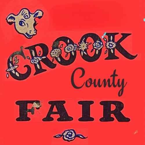 Red background poster for Crook County Fair with a goat illustration, decorated with flowers, and stylized text.
