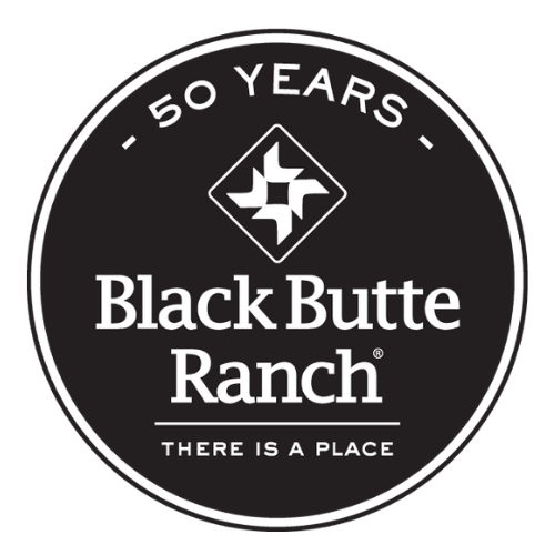 A circular logo celebrating 50 years of Black Butte Ranch, featuring a stylized geometric mountain design and the slogan 'There is a Place'.