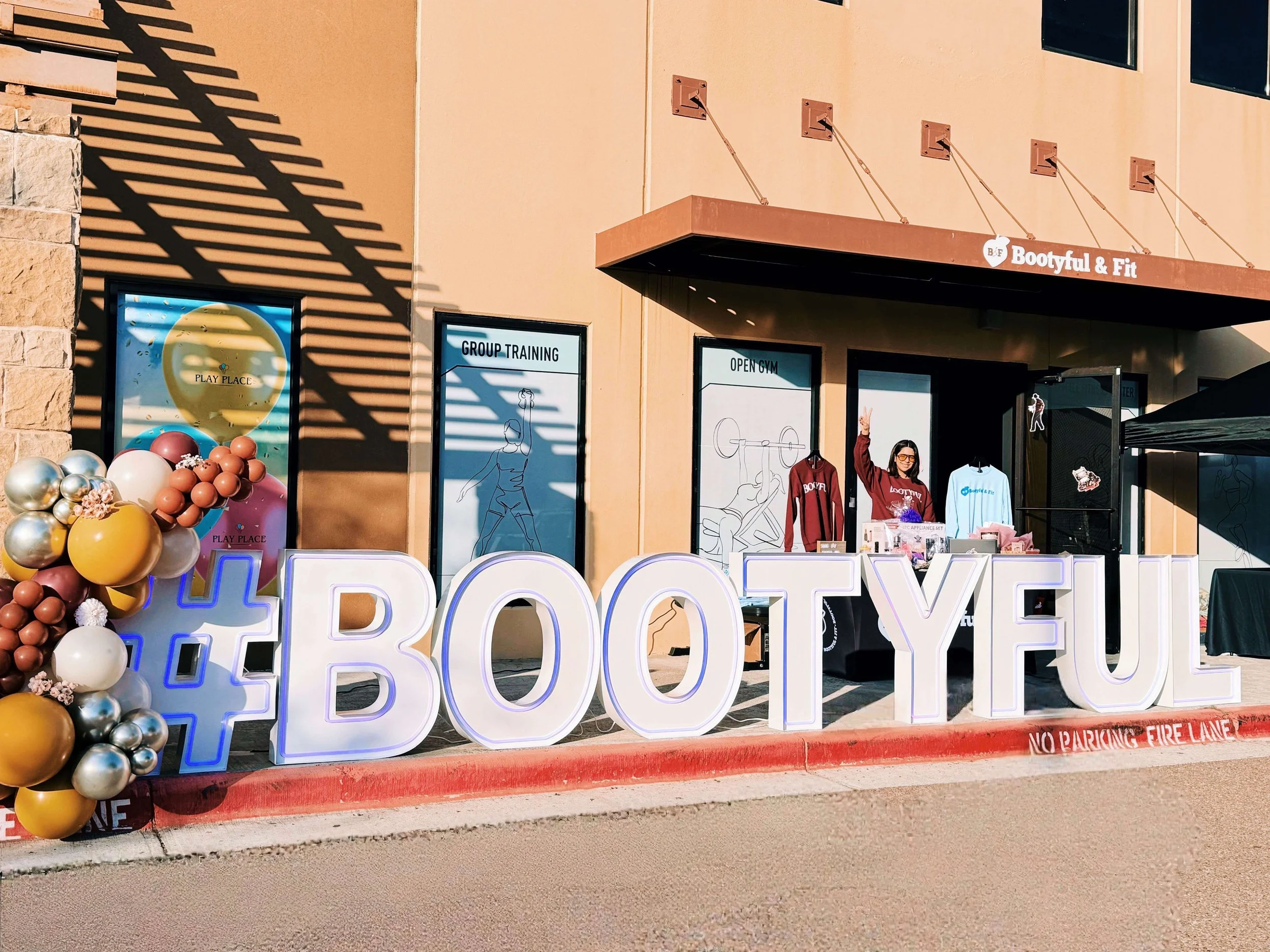 LED marquee letters spelling “BOOTYFUL” displayed outdoors for a fitness studio brand event and business activation.