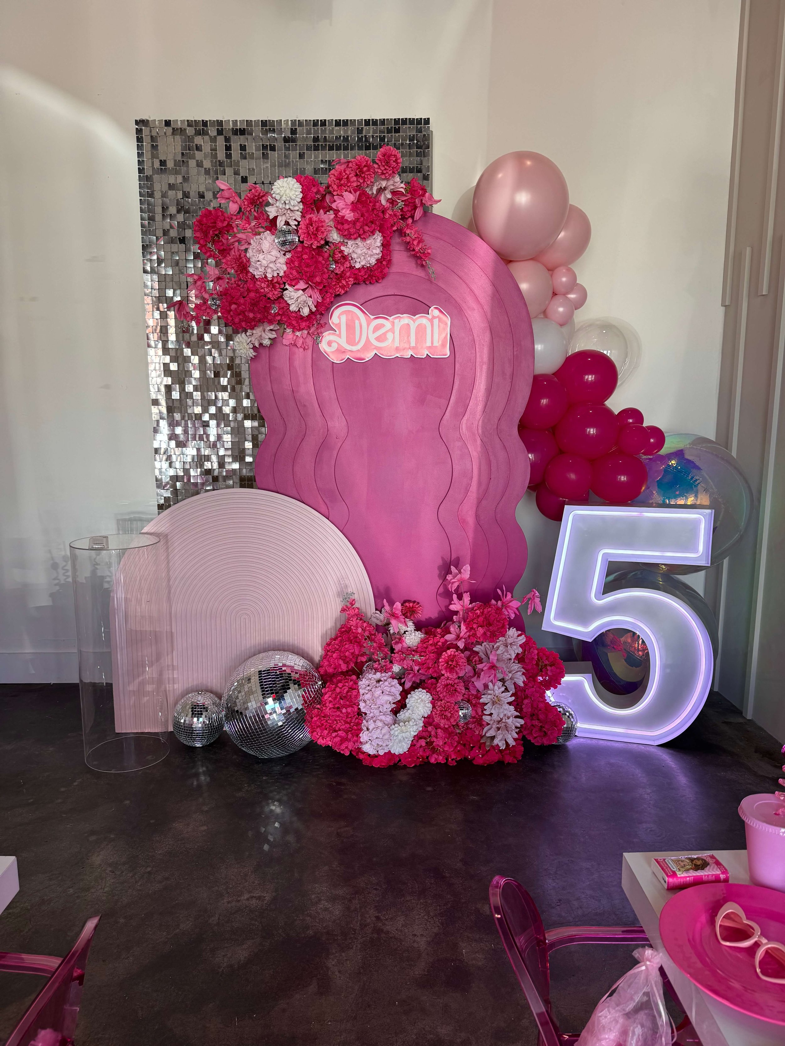 Pink Barbie-themed backdrop with illuminated number 5 LED marquee.