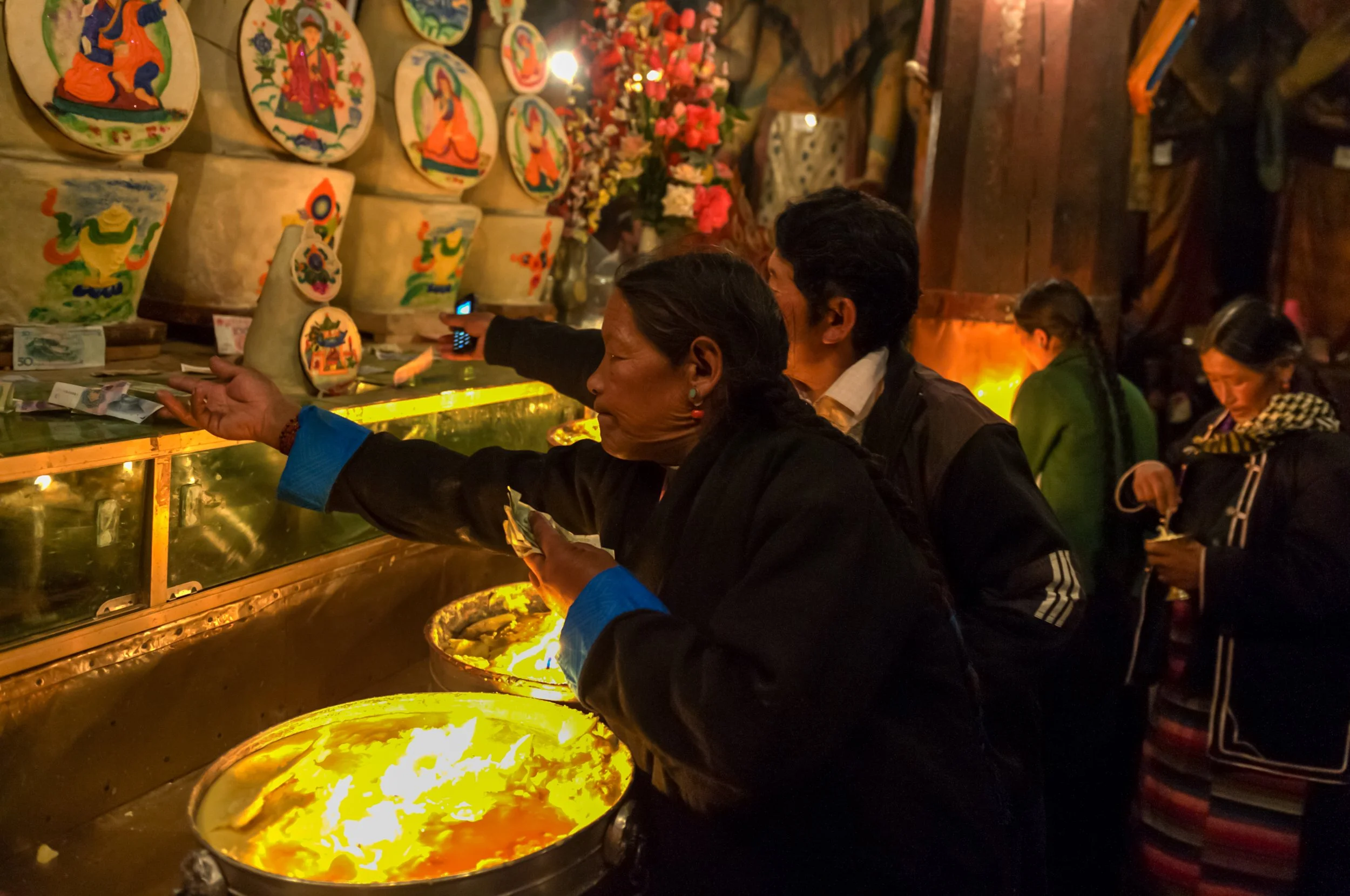 People lighting butter lamps.jpg