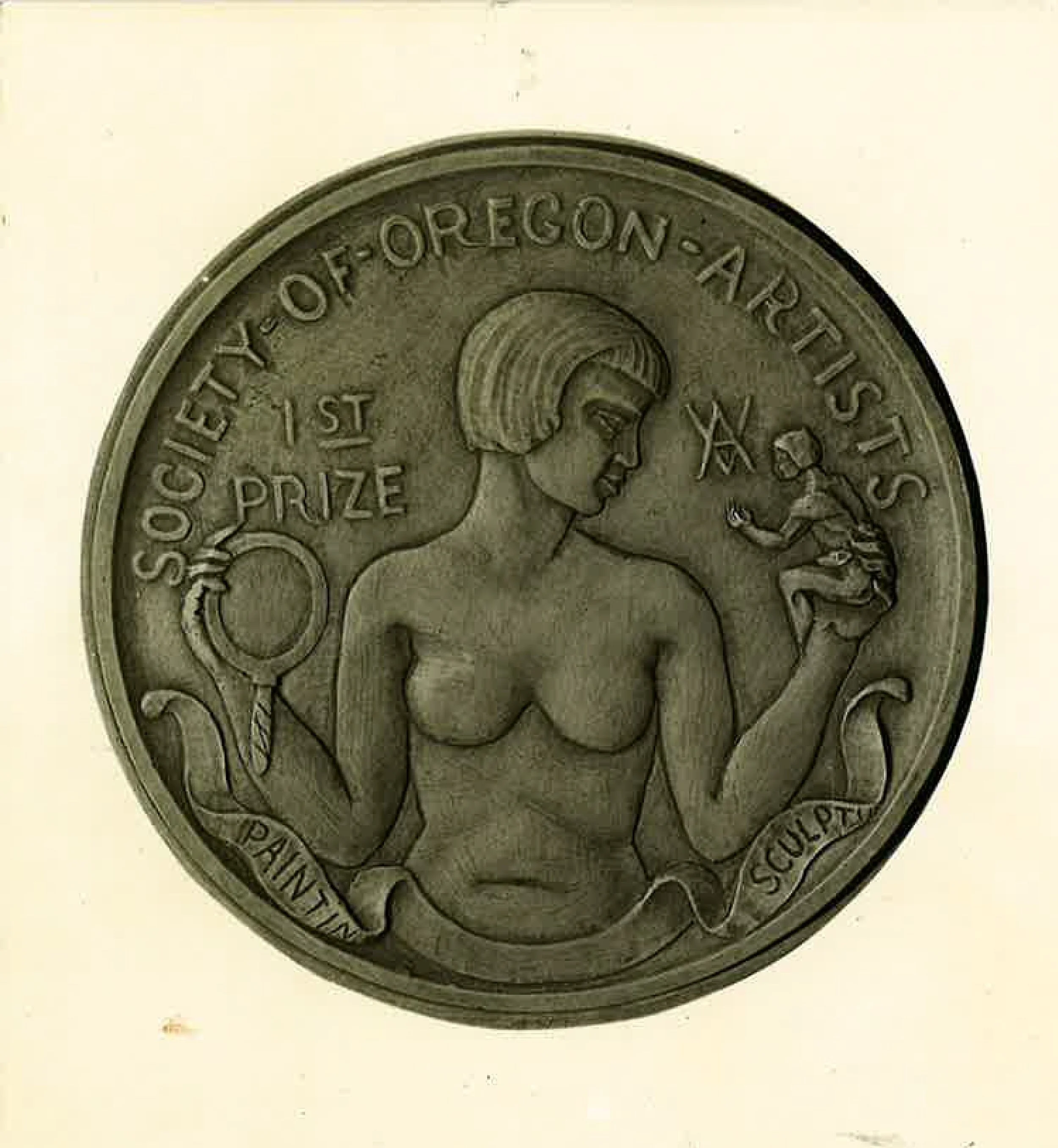 Vintage coin from Oregon Art Institute featuring a woman with a bob haircut holding a mirror in one hand and a small sculpture in the other, with inscriptions about the Oregon Society of Artists and a prize for print sculpture.