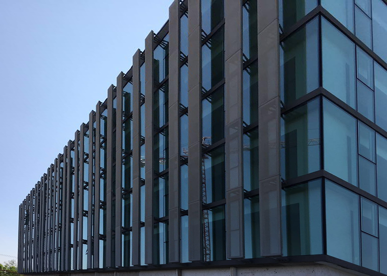 Revestimiento de fachada en metal desplegado arquitectónico, proyecto institucional en Chile, solución de control solar y permeabilidad visual desarrollada por NENZI Arq.