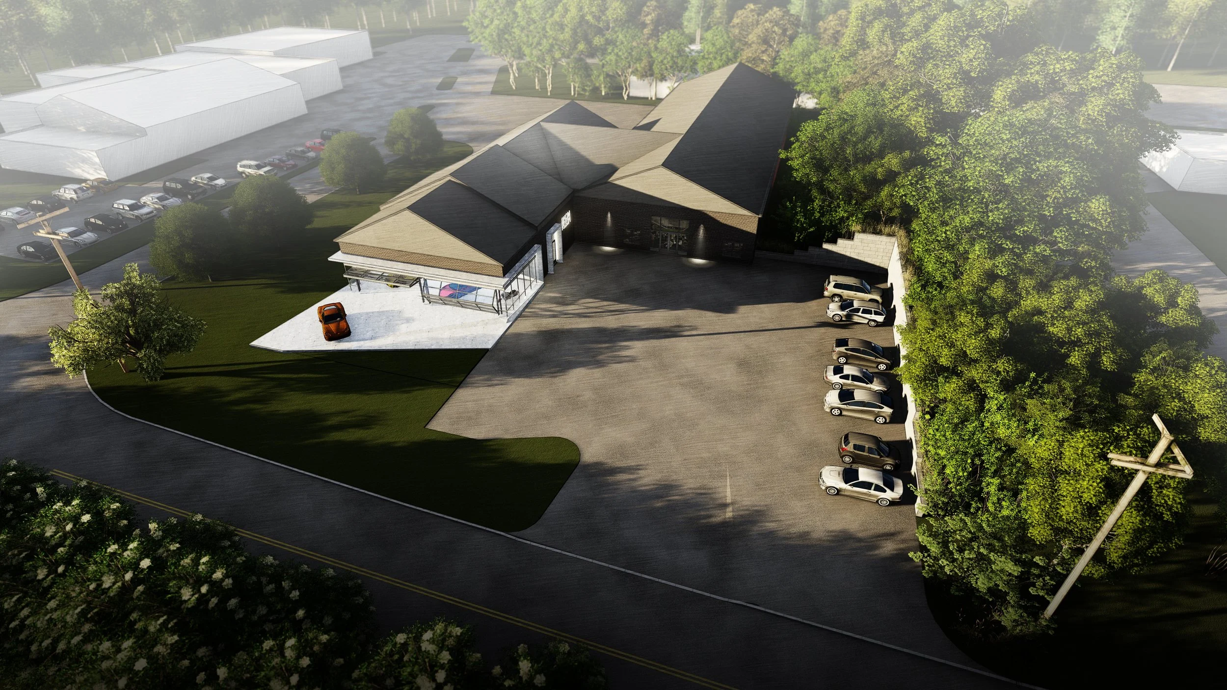 Aerial view of a modern building with a large parking lot surrounded by trees and green lawns, with cars parked along the sides and in front by brahlerdesign.