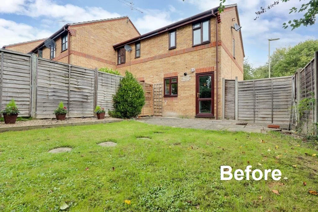 Backyard of a brick house with a lawn, a small bush, and a fenced perimeter. The image is labeled "Before."