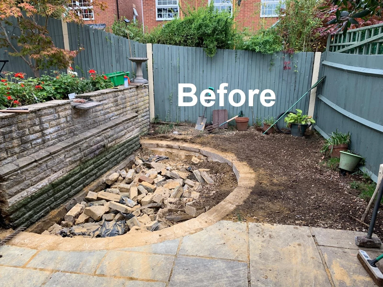 Backyard with a brick wall, garden, and tools, showing a garden renovation in progress, labeled 'Before'.