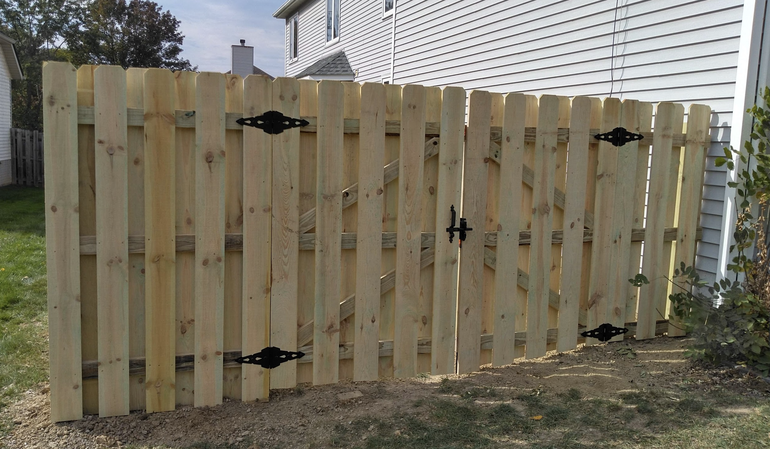 Double wooded gate with black hinges