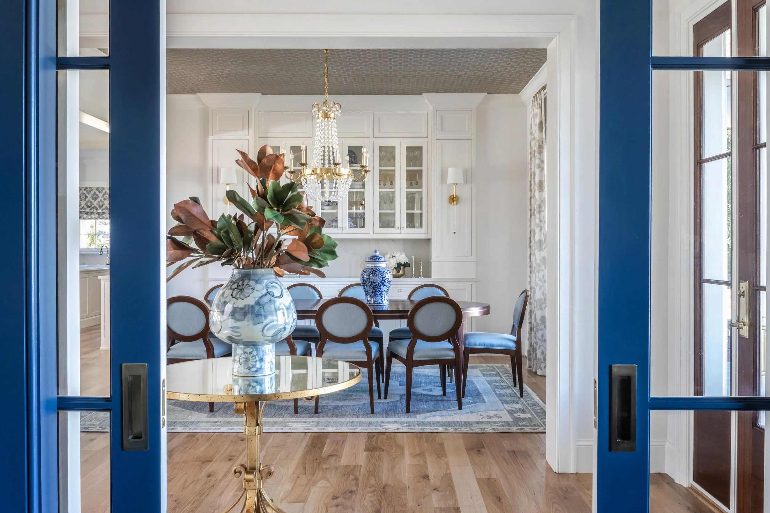 Some rooms are designed to stand alone. Others are designed to speak to each other. ✨

From the office, every detail draws you forward &mdash; the bold blue doors, layered lighting, warm wood tones, and gathered dining space beyond. Thoughtful sightl