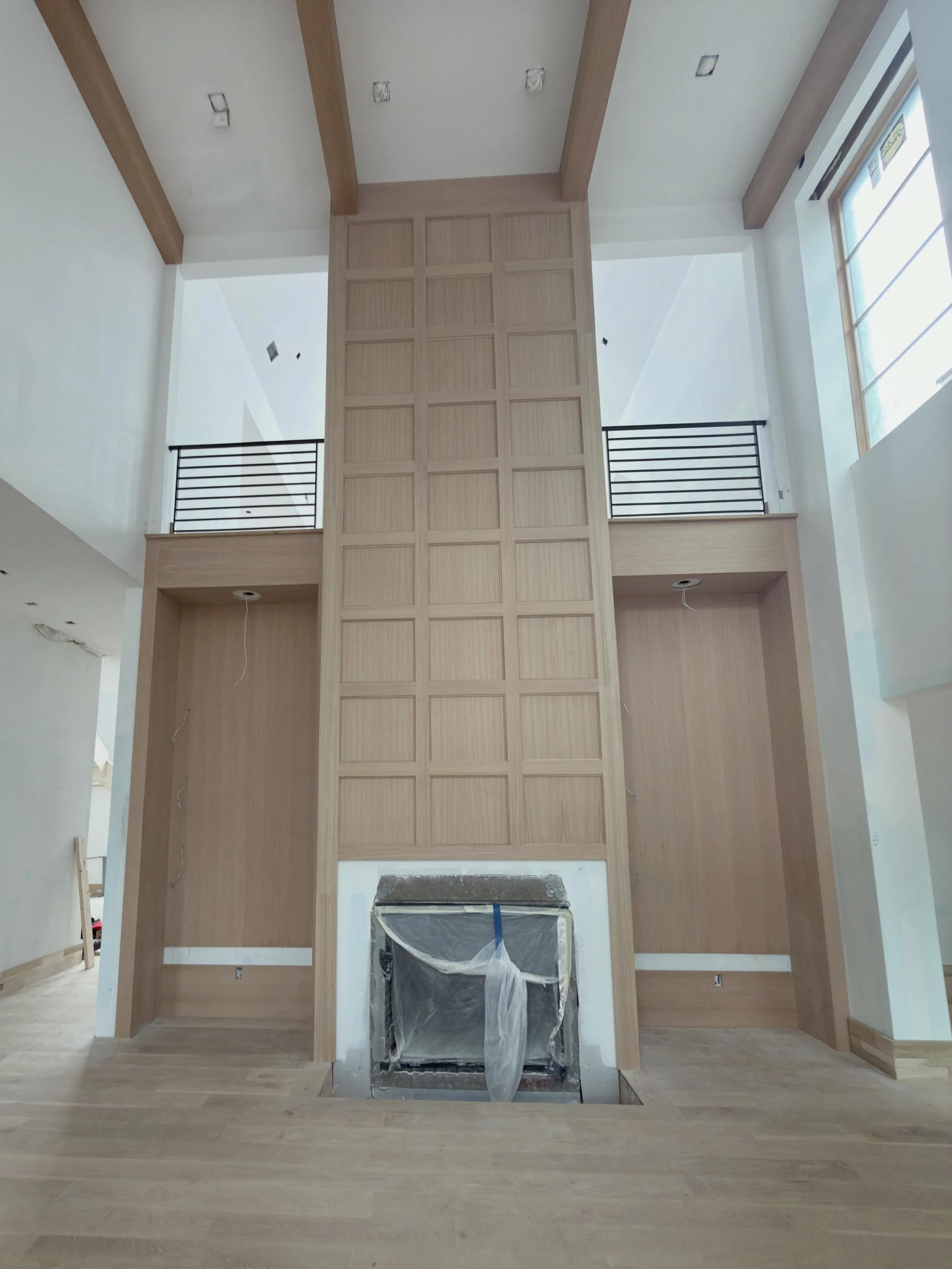 Framing every detail to make a statement ✨
From the custom white oak ceiling beams to the dramatic paneled fireplace wall, this Lehigh home is coming to life in the best way. The scale, natural light, and warmth of the finishes create a space that fe