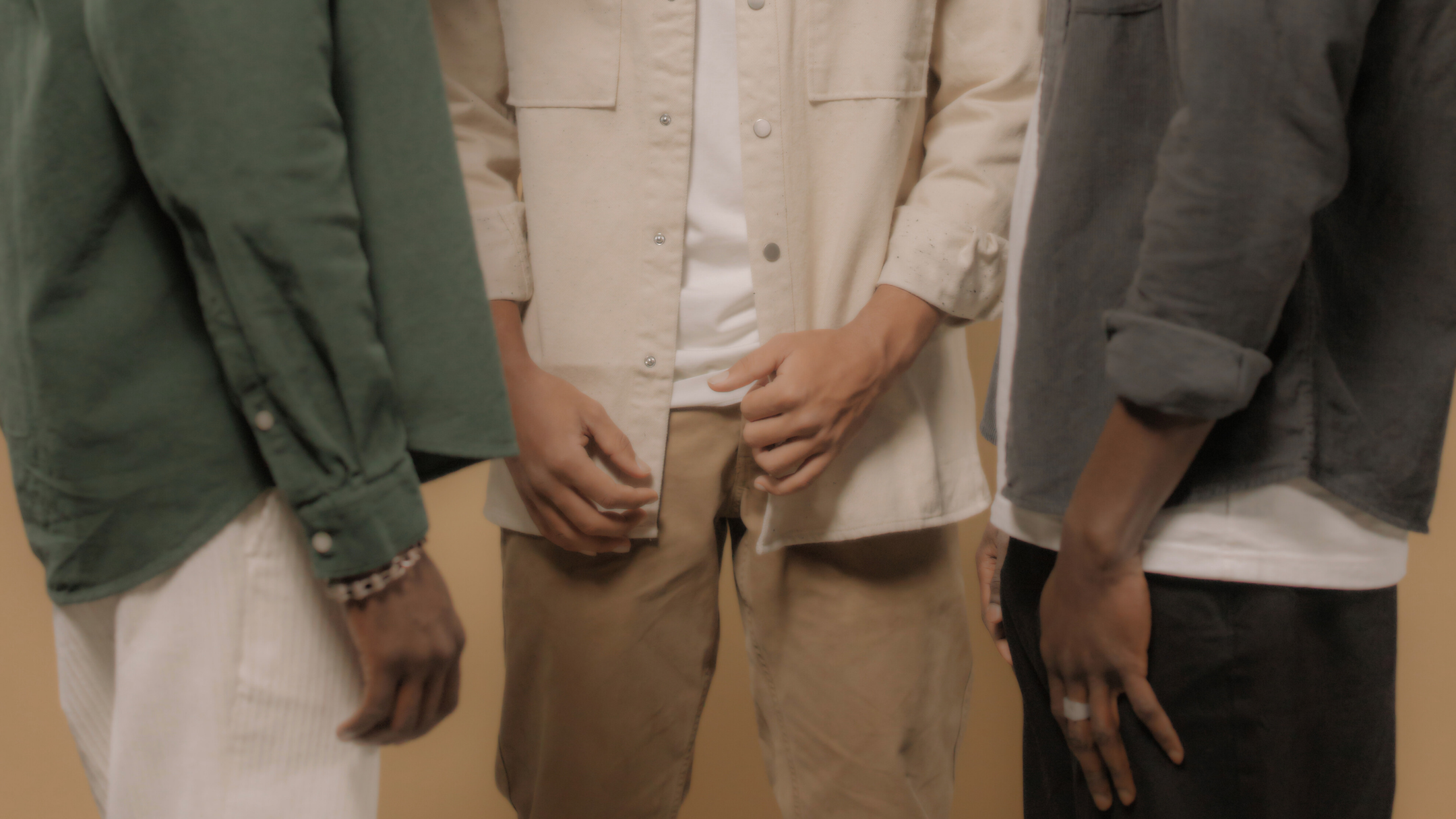 Three men standing together in casual attire, representing men exploring penile girth enhancement options