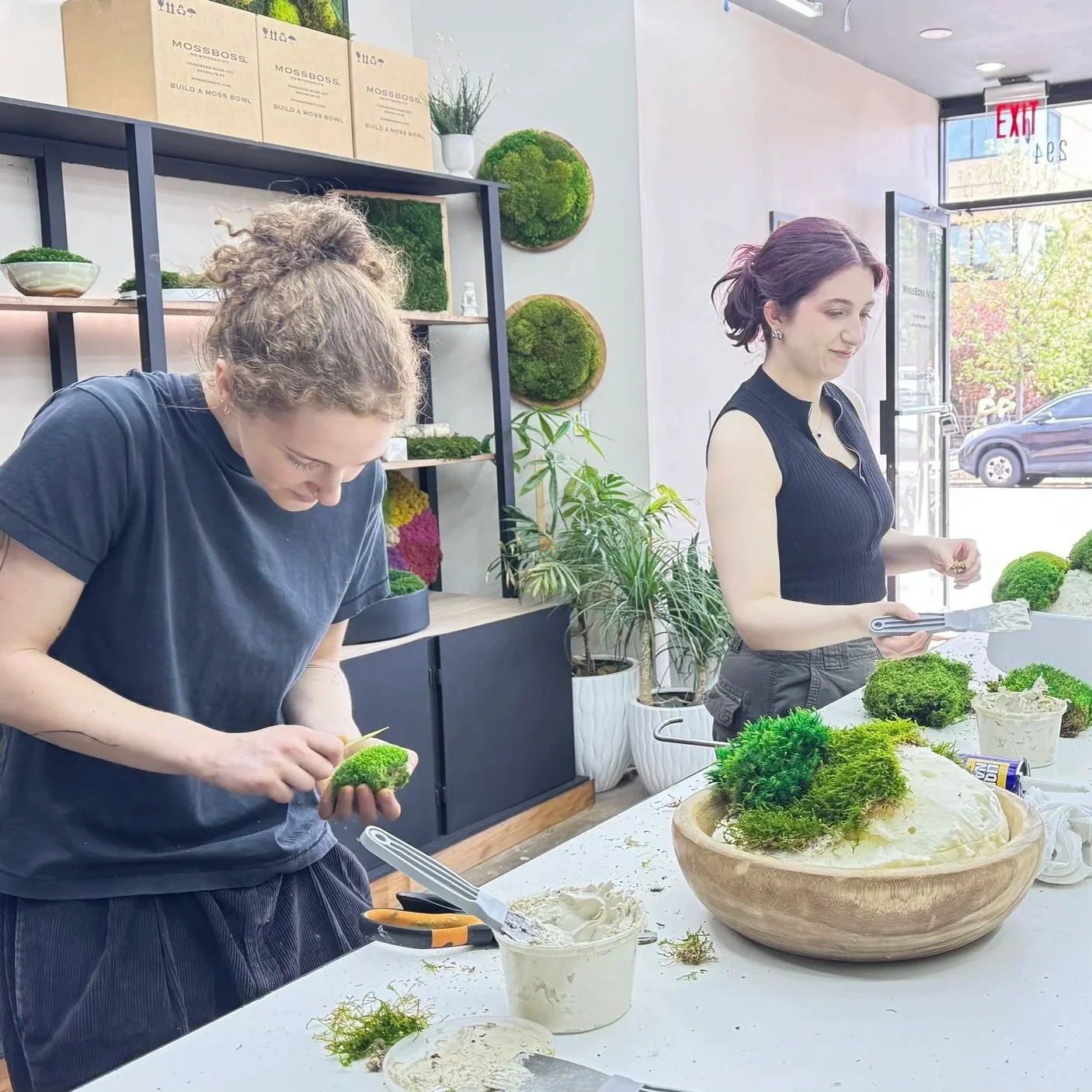 two women building moss bowls during a MossBoss NYC class