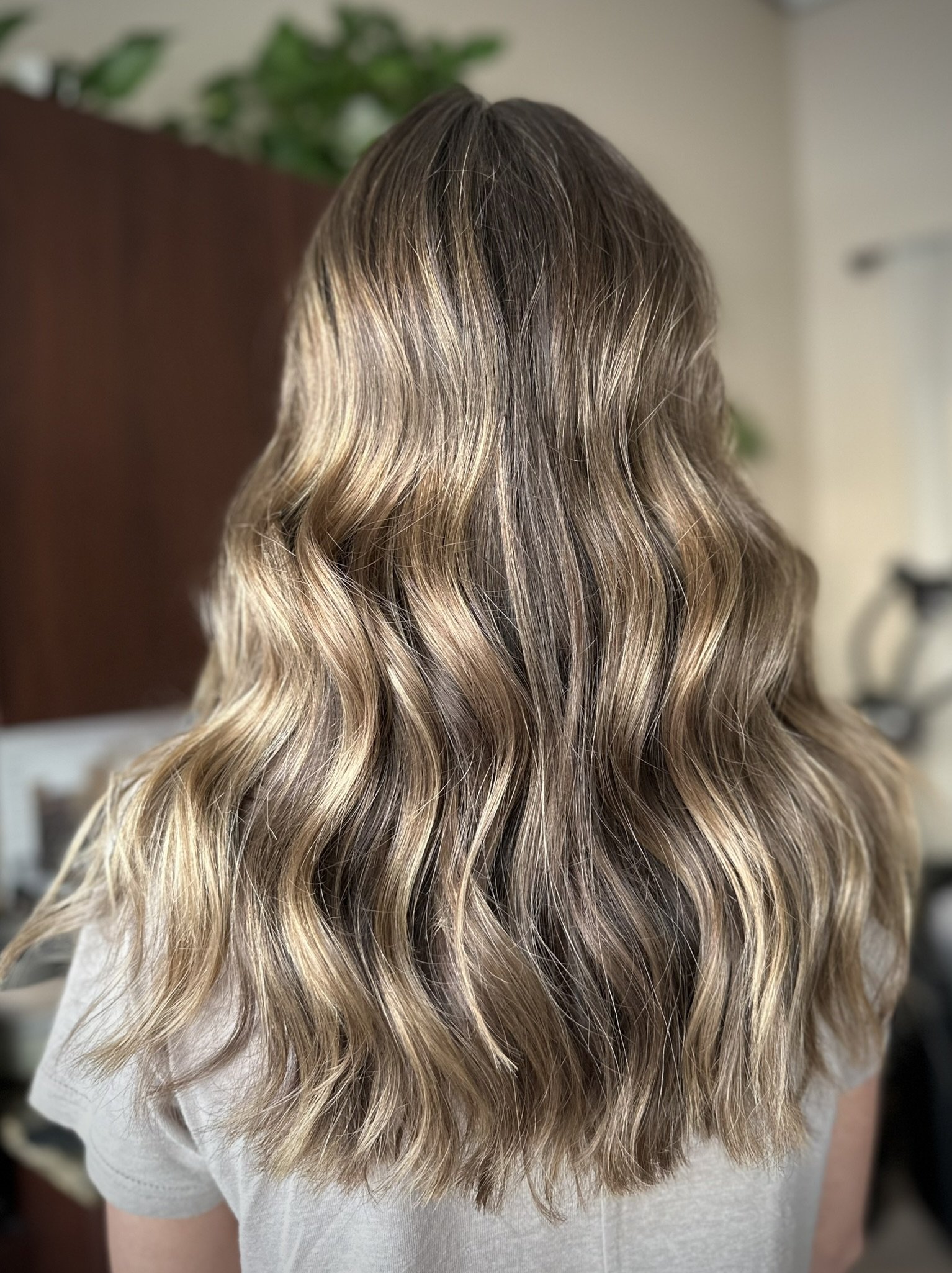 Bronde hair color with seamless balayage, bright face-framing highlights, and a low-maintenance grow-out by Leah Taylor Salon in St. Petersburg, Florida.