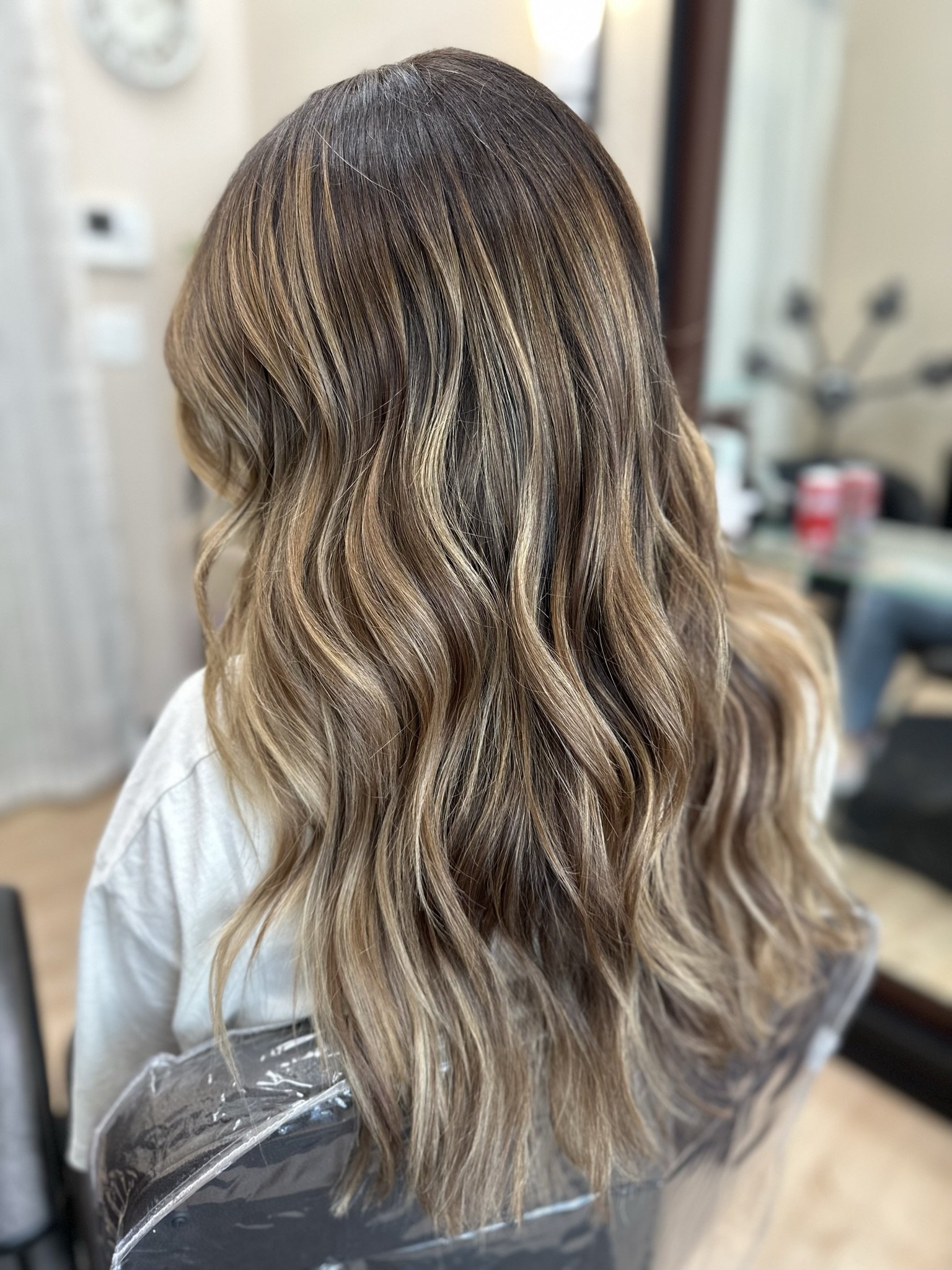 Low-maintenance bronde hair color with dimensional highlights and natural root melt created by Leah Taylor Salon in St. Petersburg, Florida.