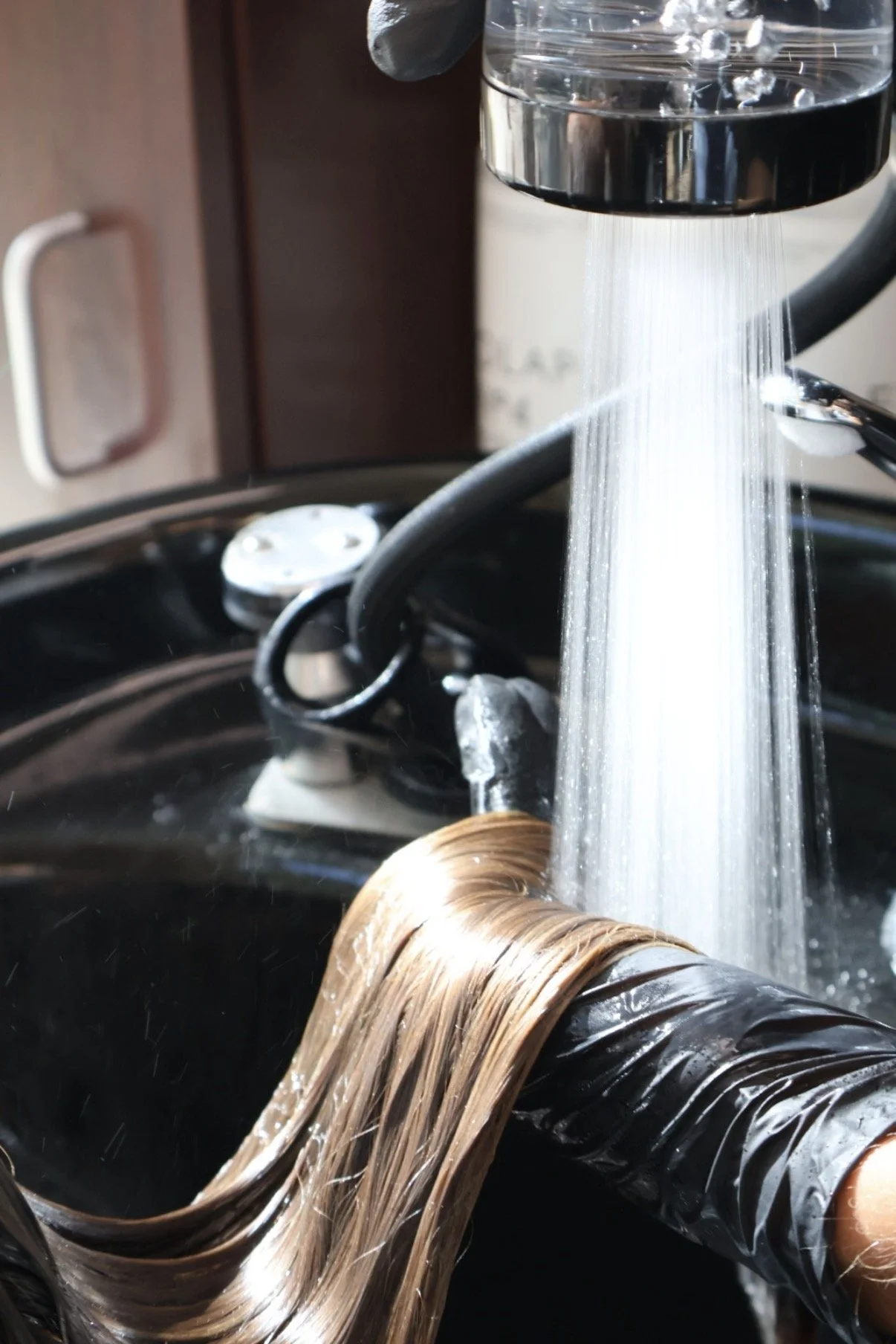 Relaxing head spa rinse and scalp treatment designed to promote scalp health, hydration, and a luxury self-care experience at Leah Taylor Salon in St. Petersburg, Florida.