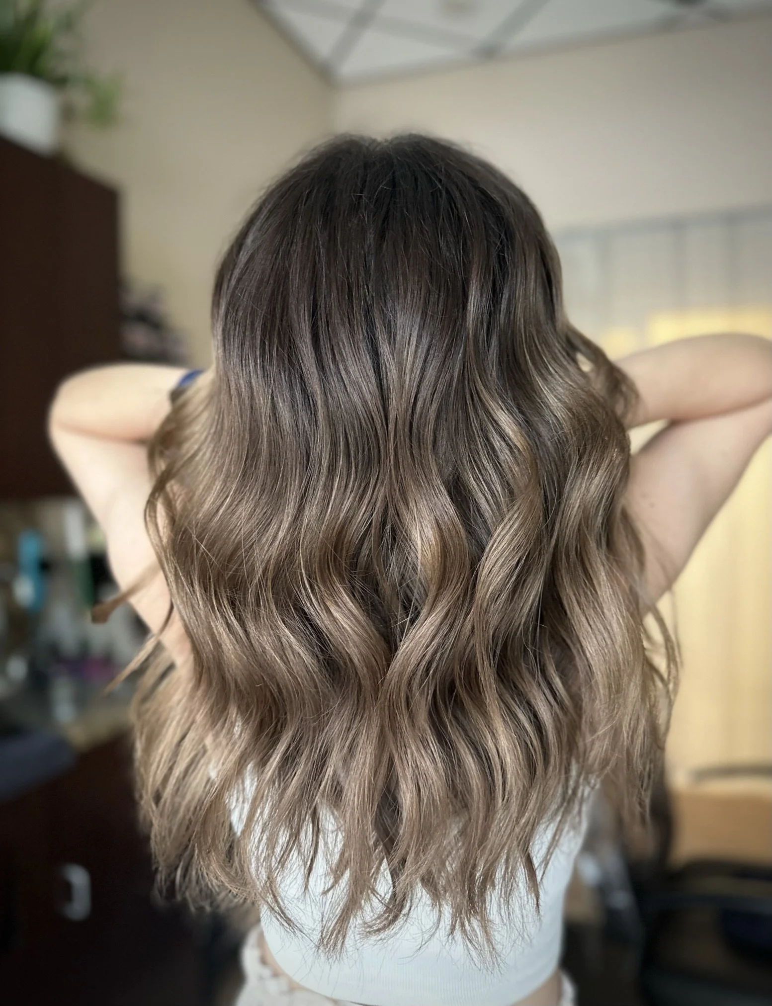 Soft mushroom bronde hair featuring cool beige highlights and natural dimension by Leah Taylor Salon in St. Petersburg, Florida.