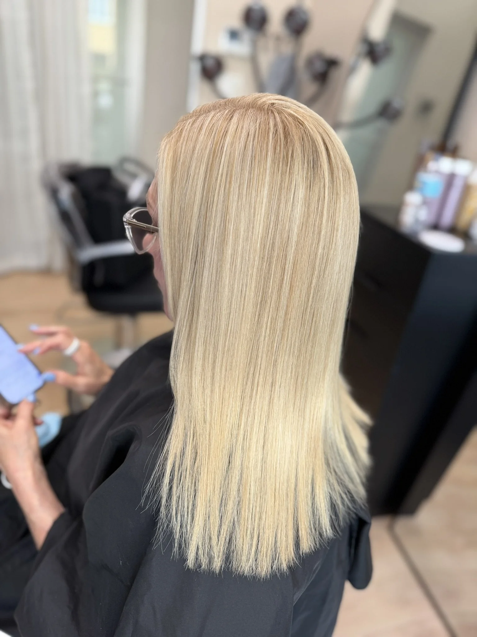 Bright blonde highlights used to blend gray hair seamlessly with a soft, dimensional, low-maintenance finish by Leah Taylor Salon in St. Petersburg, Florida.
