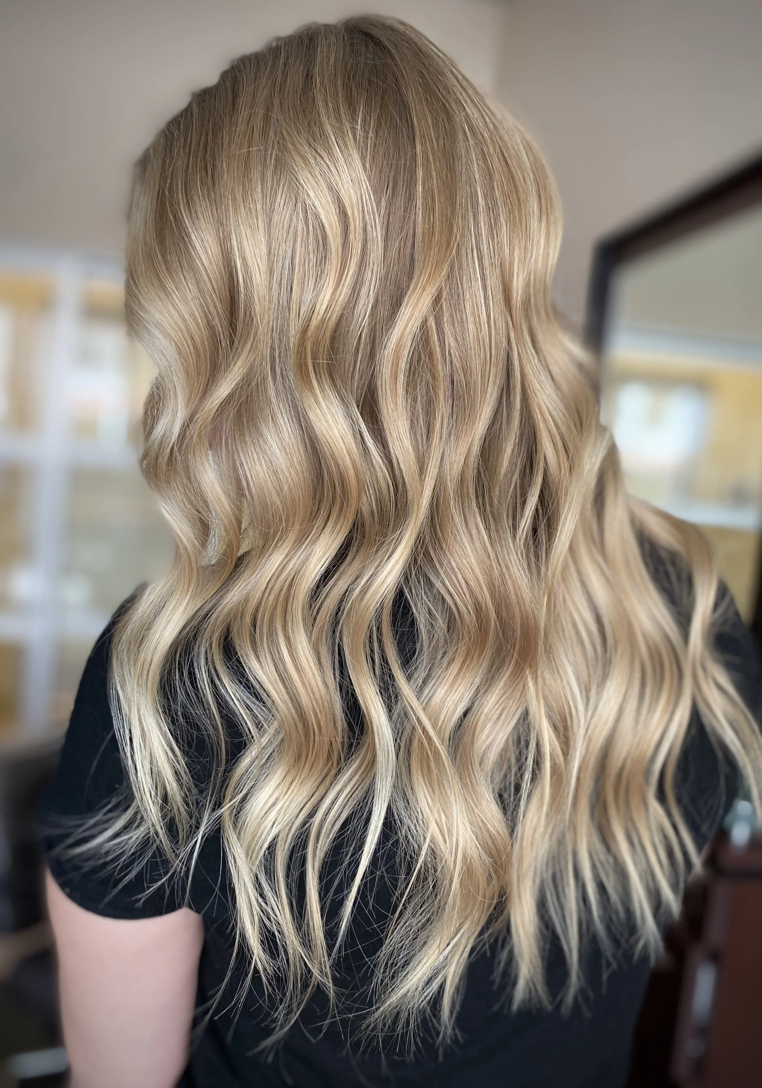 Buttery Champagne blonde balayage featuring dimensional beige blonde tones and seamless lived-in color created by Leah Taylor Salon, a blonde specialist in St. Petersburg, Florida.