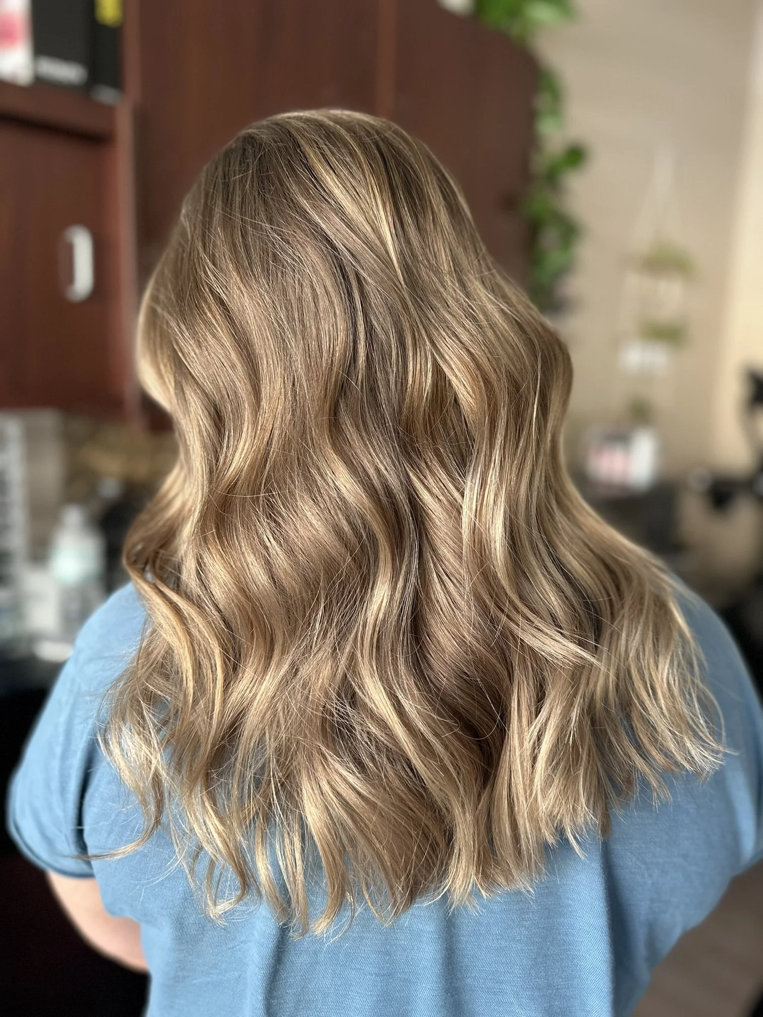 Dimensional bronde hair with soft blonde ribbons, lived-in depth and beachy waves by Leah Taylor Salon in St. Petersburg, Florida.