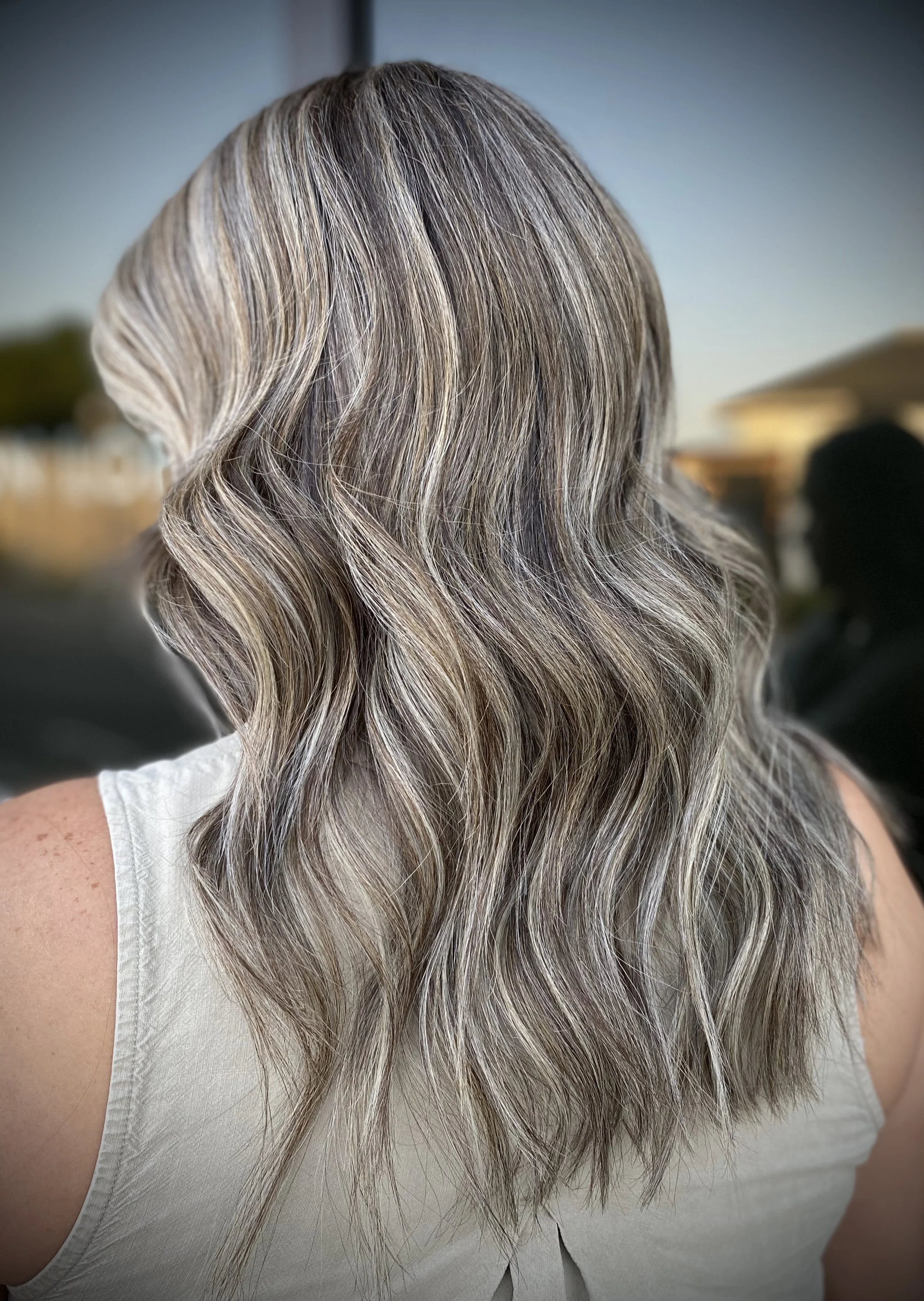 Luxury gray blending service featuring cool blonde highlights and dimensional lowlights for a seamless, low-maintenance grow-out by Leah Taylor Salon in St. Petersburg, Florida.