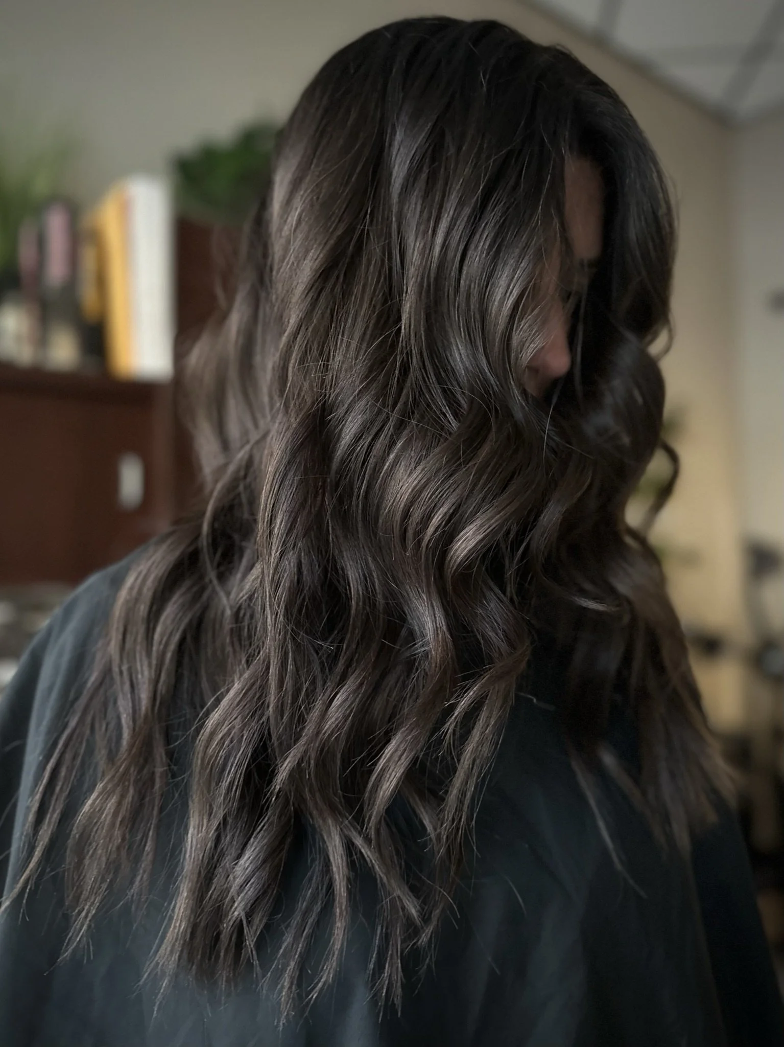 Dimensional espresso brunette hair with rich mocha tones, glossy shine, and soft lived-in waves by Leah Taylor Salon in St. Petersburg, Florida.