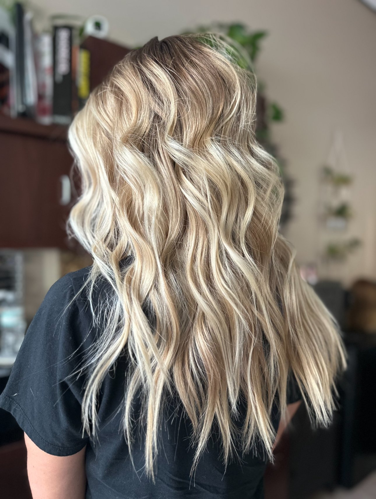 Low-maintenance lived-in blonde balayage with bright blonde highlights, dimensional color, and a soft root melt by Leah Taylor Salon in St. Petersburg, Florida.