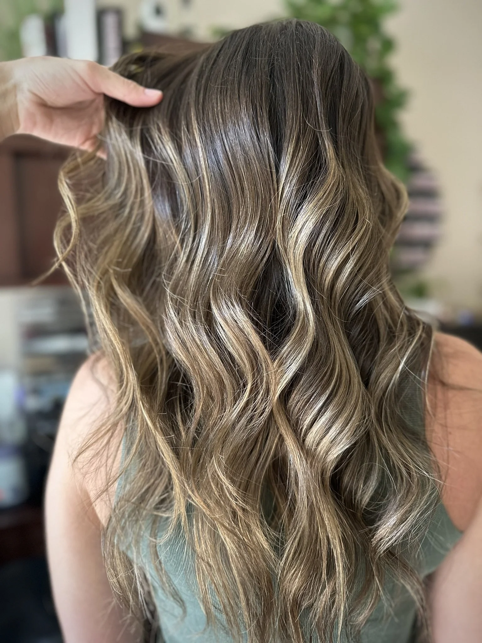 Honey bronde balayage with warm blonde highlights, dimensional brunette tones, and glossy shine by Leah Taylor Salon in St. Petersburg, Florida.