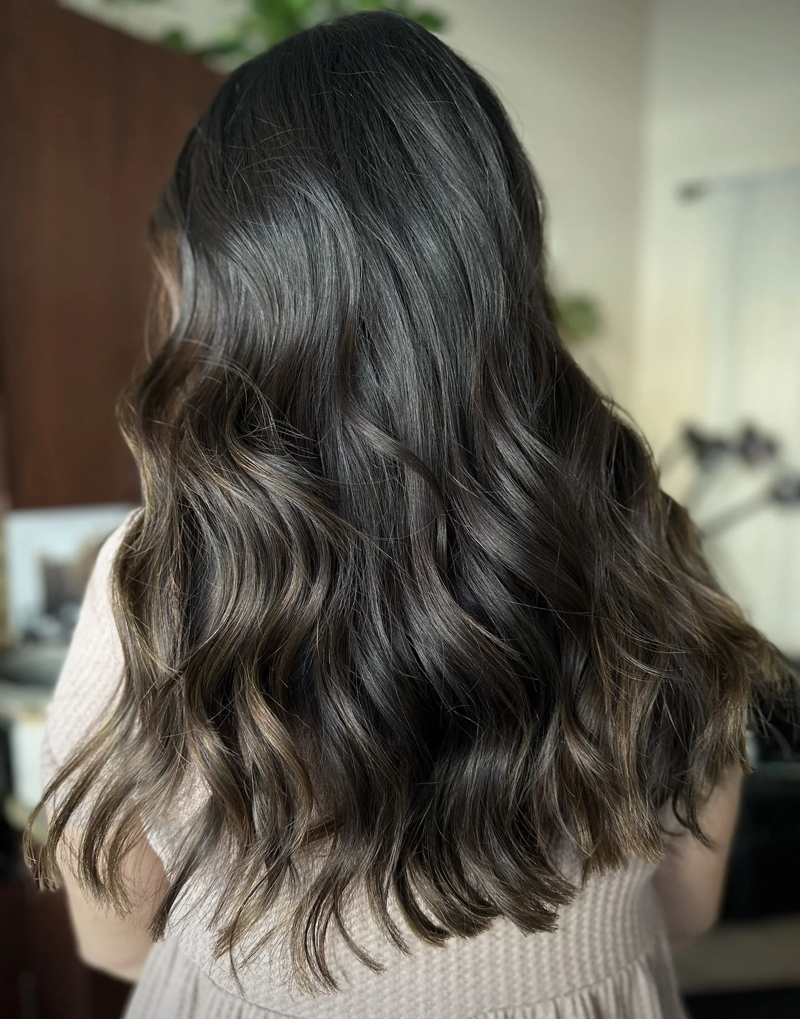 Dimensional espresso brunette hair featuring rich mocha tones, glossy shine, and soft waves created by Leah Taylor Salon in St. Petersburg, Florida.