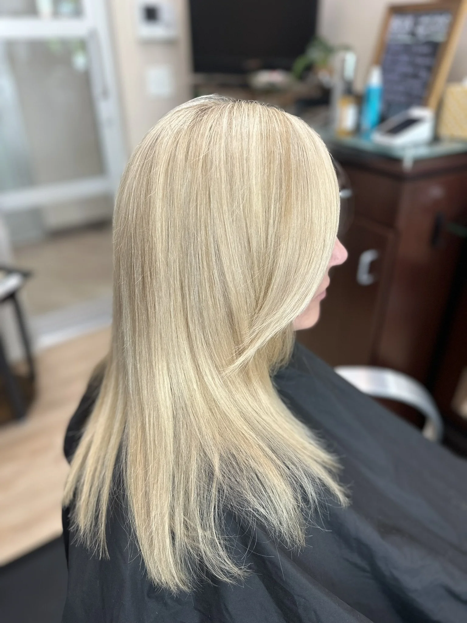 Bright blonde highlights used to blend gray hair seamlessly with a soft, dimensional, low-maintenance finish by Leah Taylor Salon in St. Petersburg, Florida.
