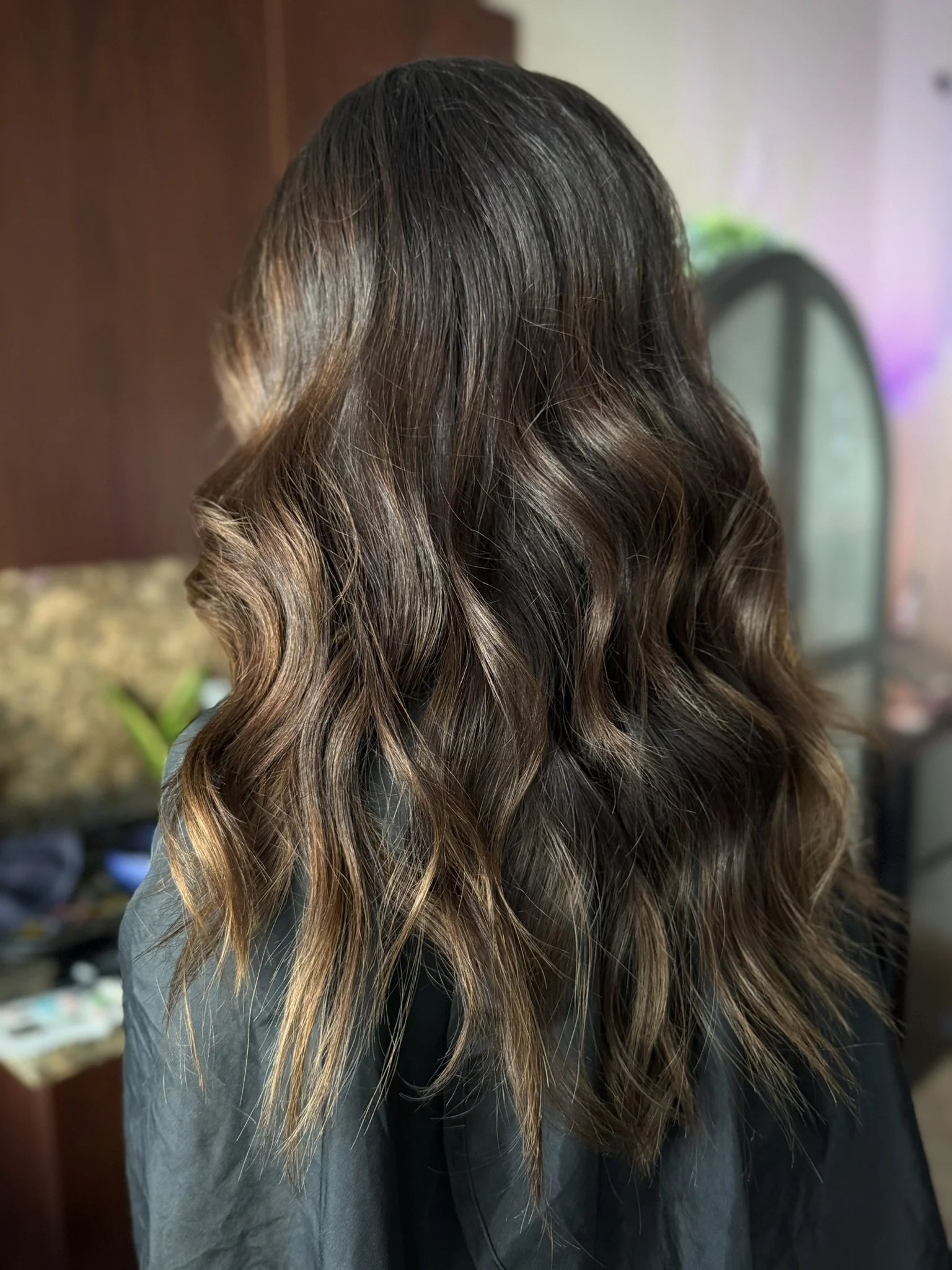 Luxury brunette hair with espresso brown tones, caramel balayage highlights, and seamless dimension by Leah Taylor Salon in St. Petersburg, Florida.