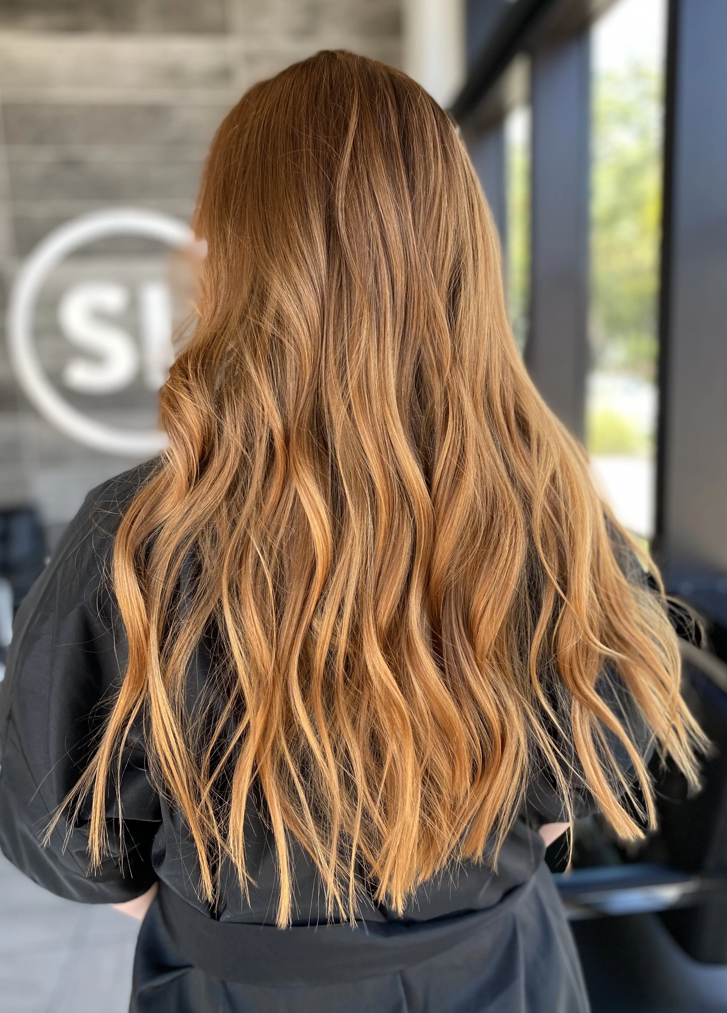 Dimensional red hair featuring copper, strawberry blonde, and cinnamon brunette tones with soft lived-in movement created by Leah Taylor Salon in St. Petersburg, Florida.