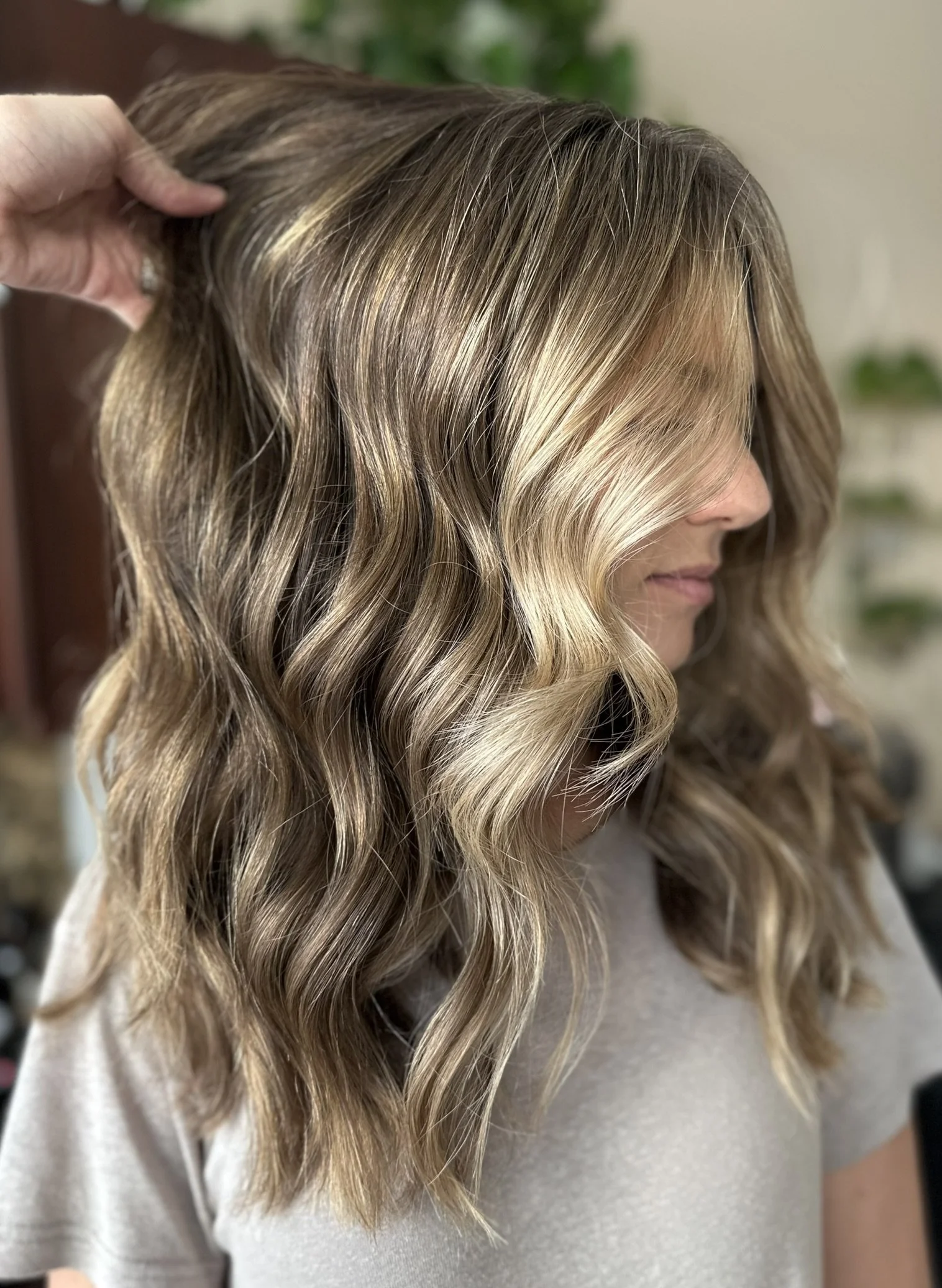 Low-maintenance bronde hair color with dimensional highlights and natural root melt created by Leah Taylor Salon in St. Petersburg, Florida.