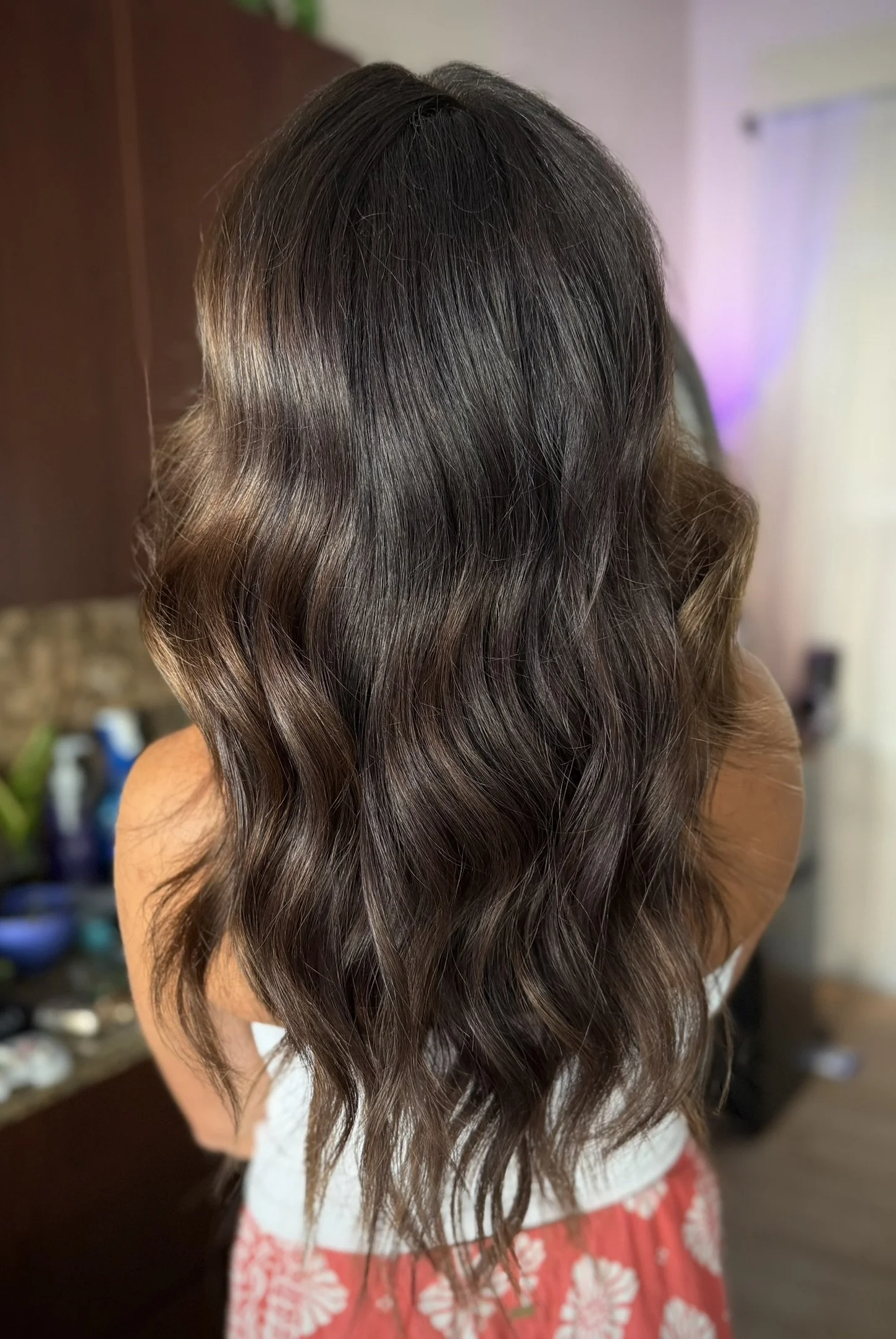 Dimensional espresso brunette hair color with rich mocha tones, soft waves, and glossy shine created by Leah Taylor Salon in St. Petersburg, Florida.