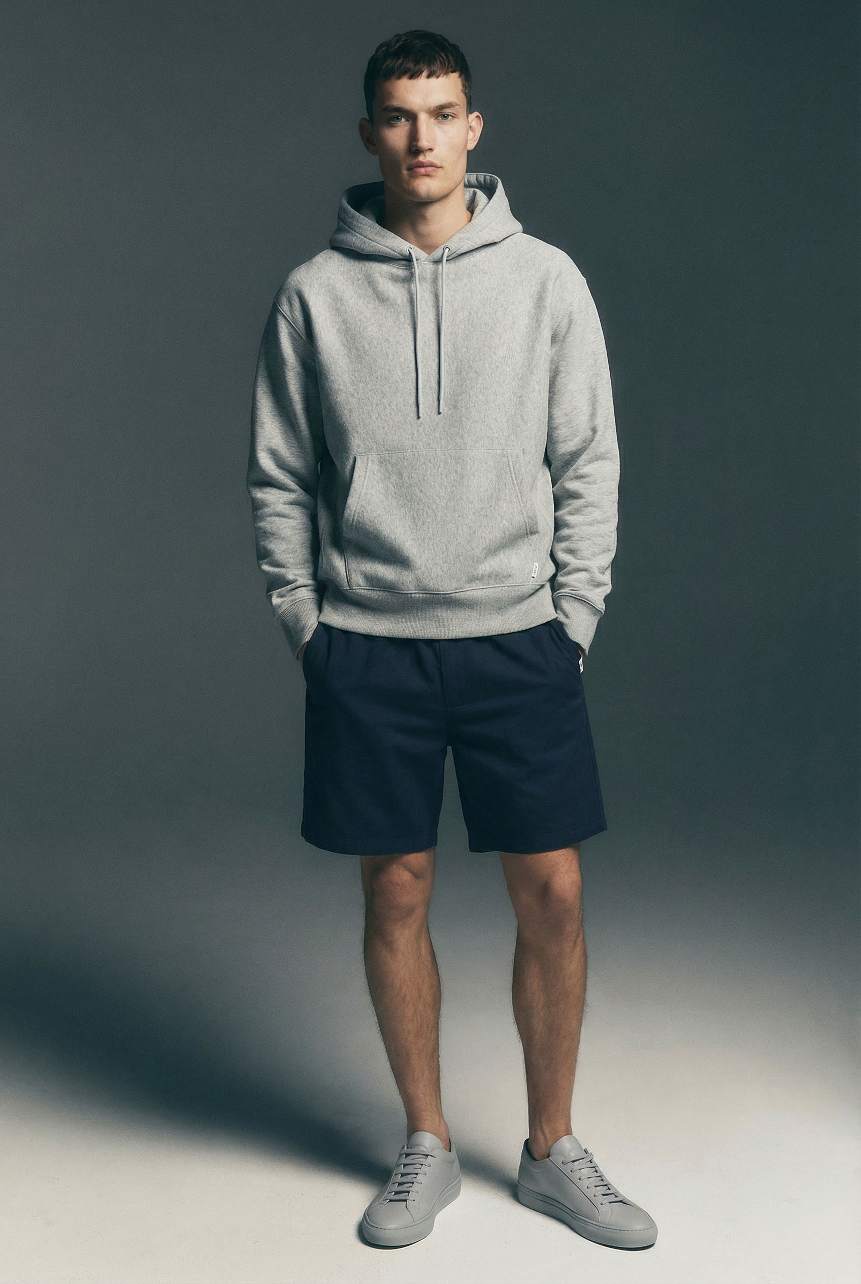 E-commerce catalog image of a male model wearing hoodie and shorts for fashion and apparel brands generated in AI.