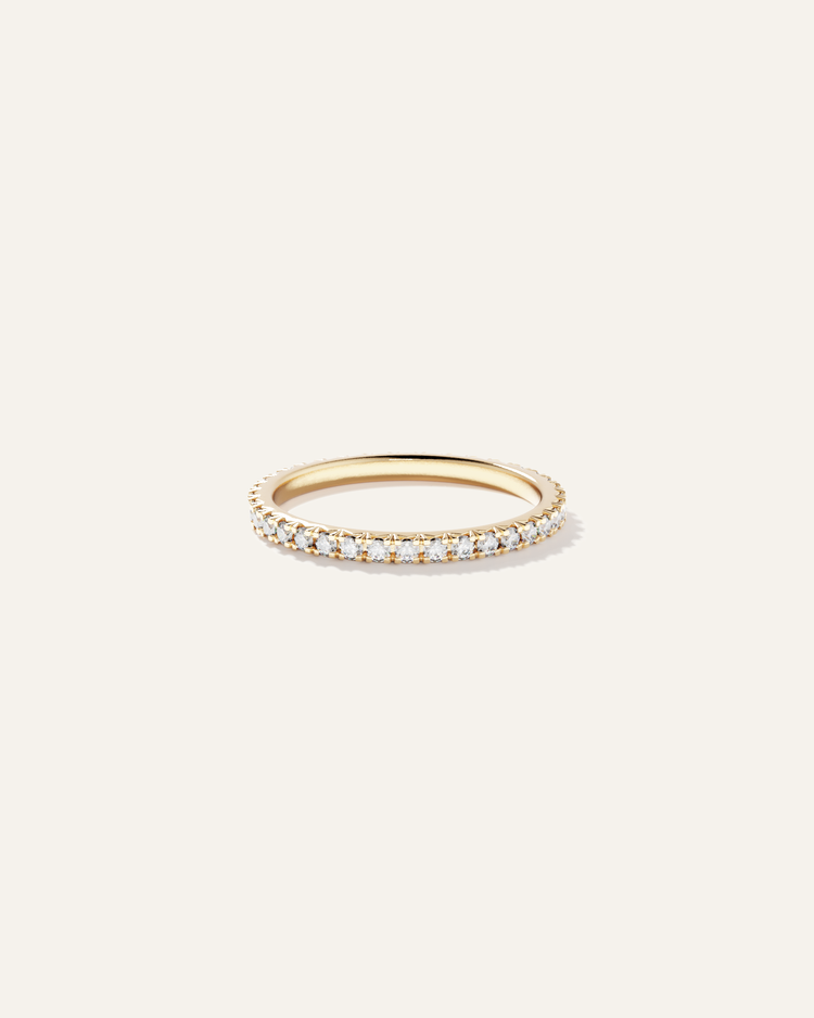 Gold ring with small diamonds on a plain, light-colored background 3D modeled and rendered for jewelry brand e-commerce catalog PDP.
