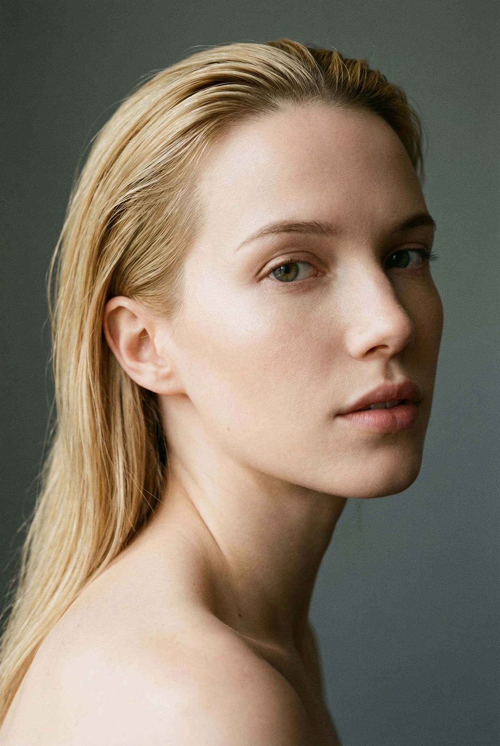 Close-up portrait against a neutral background.
