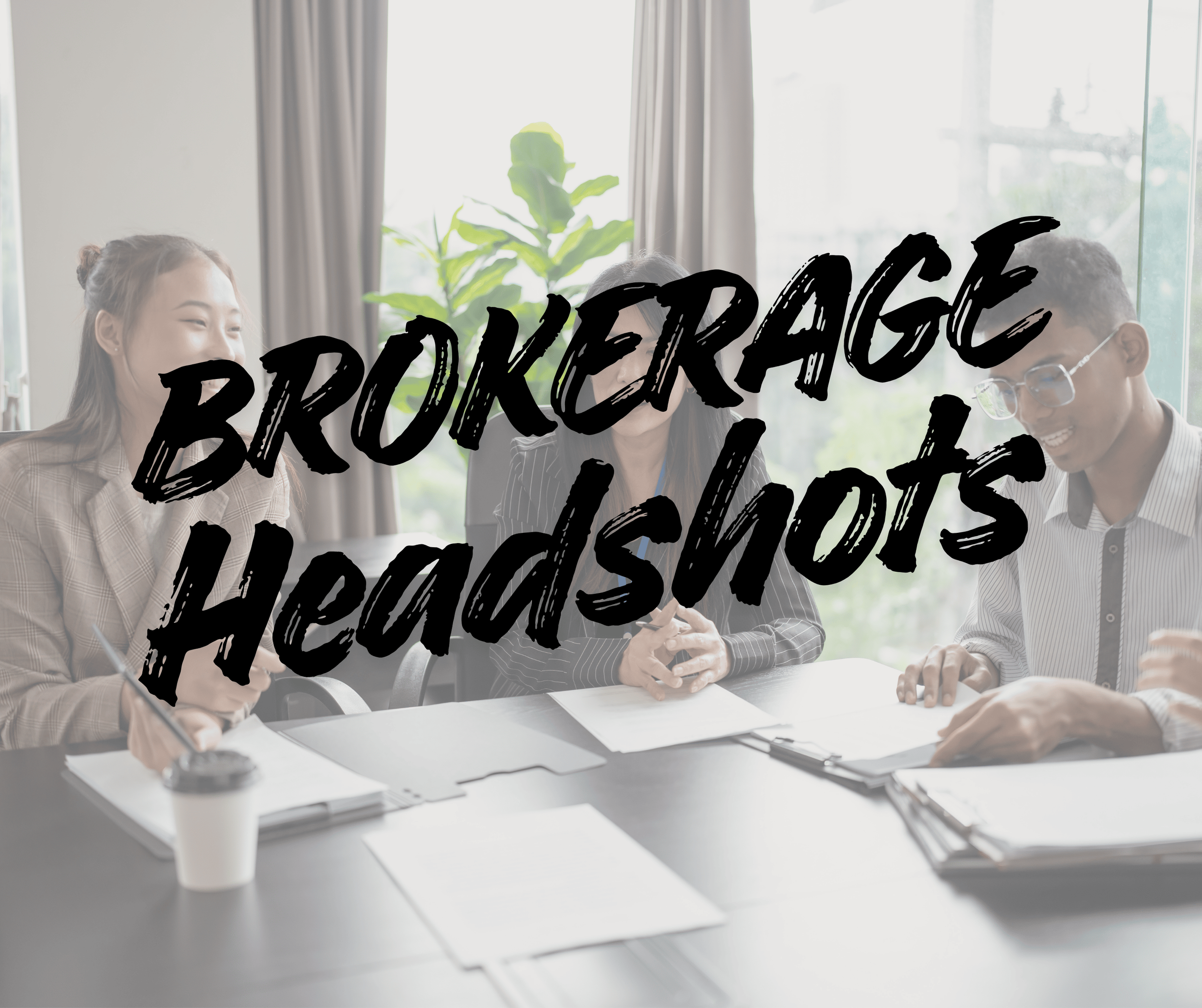 Group of three diverse business professionals collaborating at a conference table in a bright office, with papers, folders, and a coffee cup.