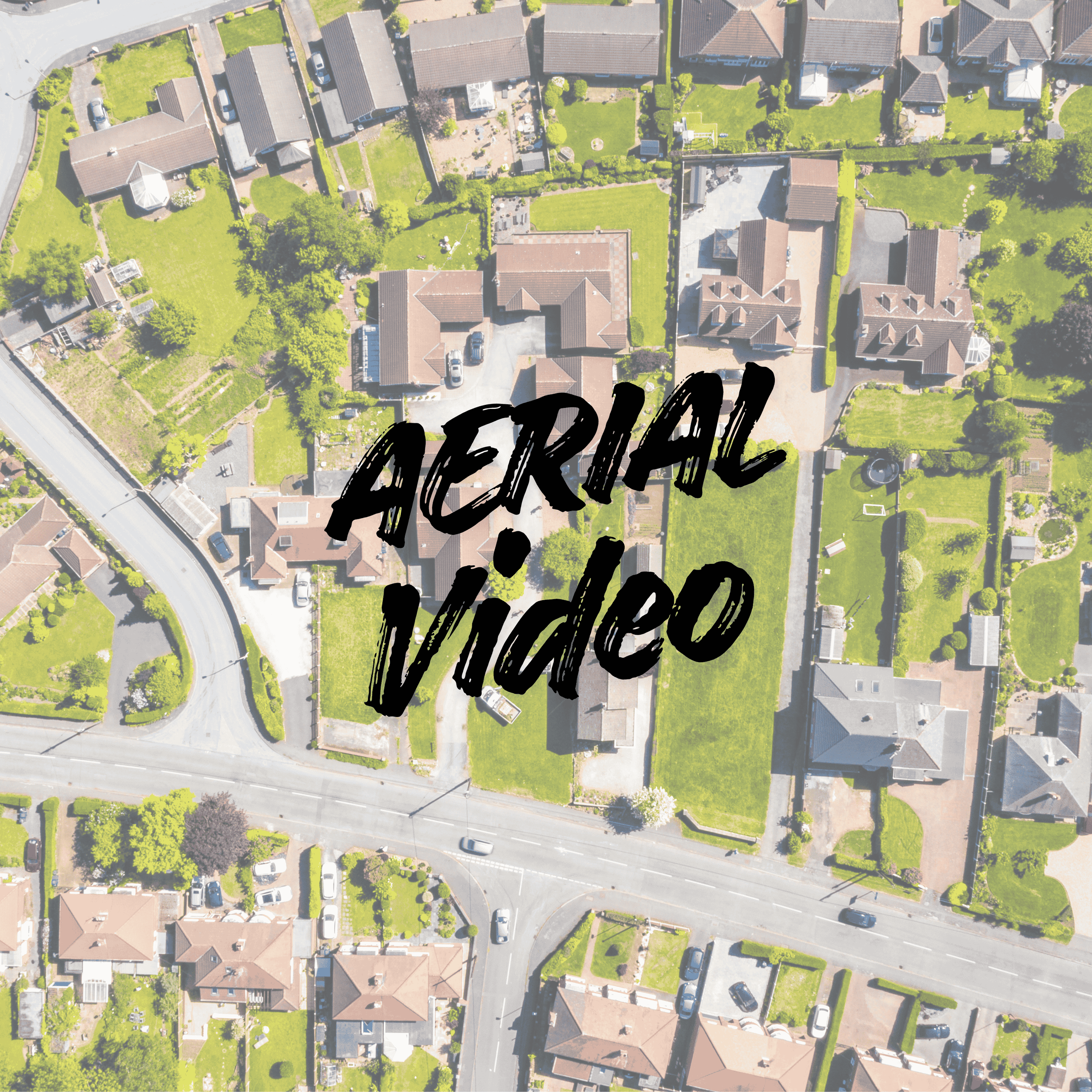 Aerial view of a residential neighborhood with houses, green lawns, trees, sidewalks, and streets. Overlaid text says "Aerial Video" in bold, black, handwritten font.