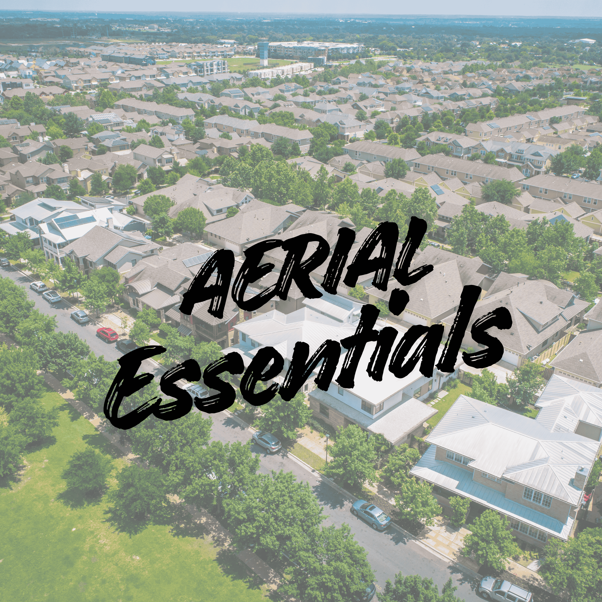 An aerial view of a neighborhood with multiple houses, trees, and streets, overlaid with the text 'AERIAL! Essentials'.