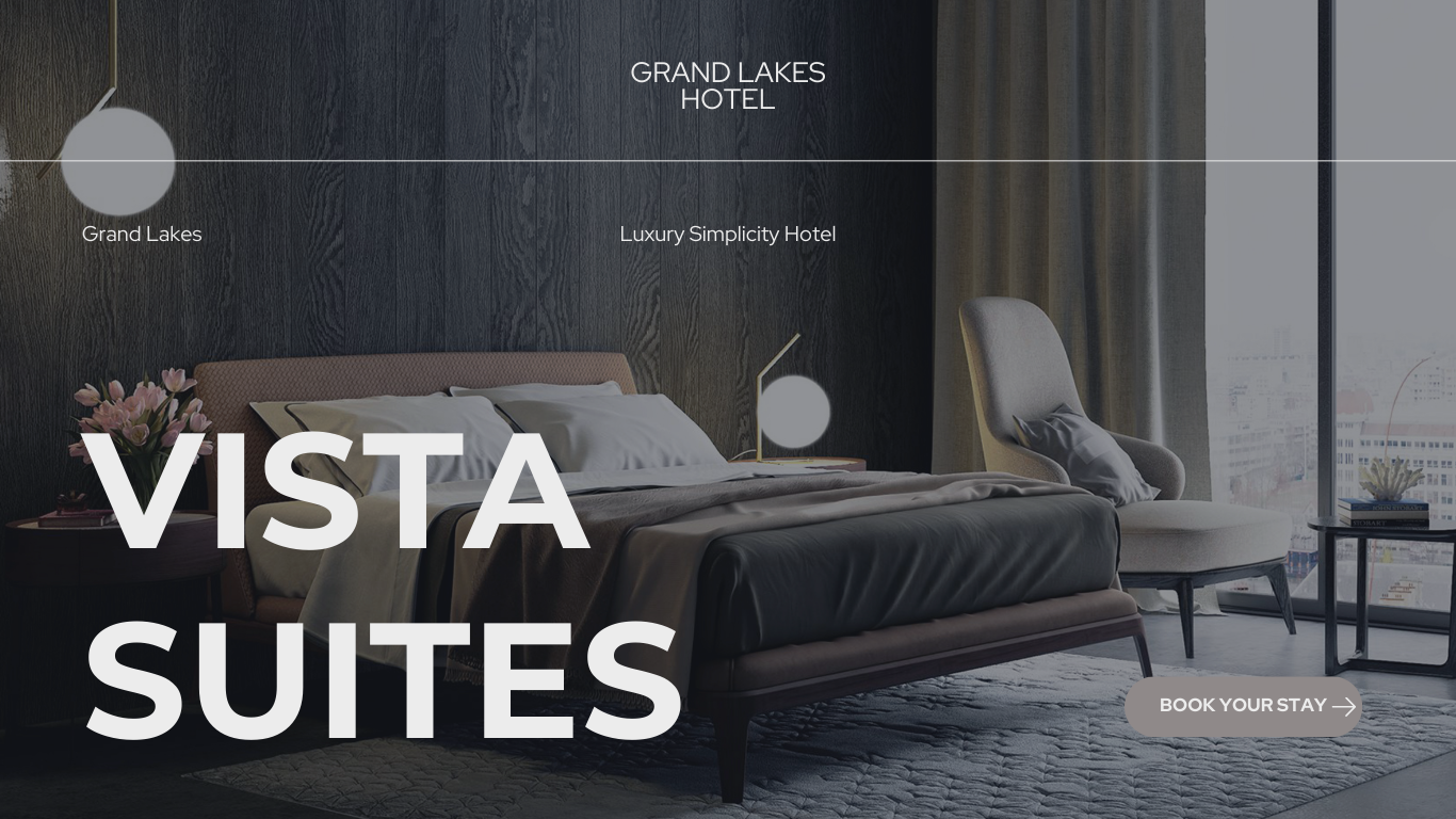 Interior of a modern hotel bedroom with a bed, side table with flowers, armchair, and large window with curtains, promoting Vista Suites at Grand Lakes Hotel.
