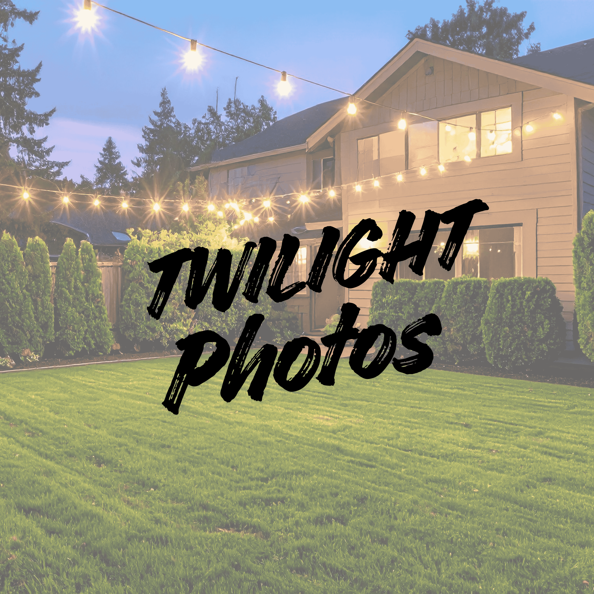 A backyard with a well-manicured lawn, green shrubs, and a house in the background illuminated by string lights during twilight.
