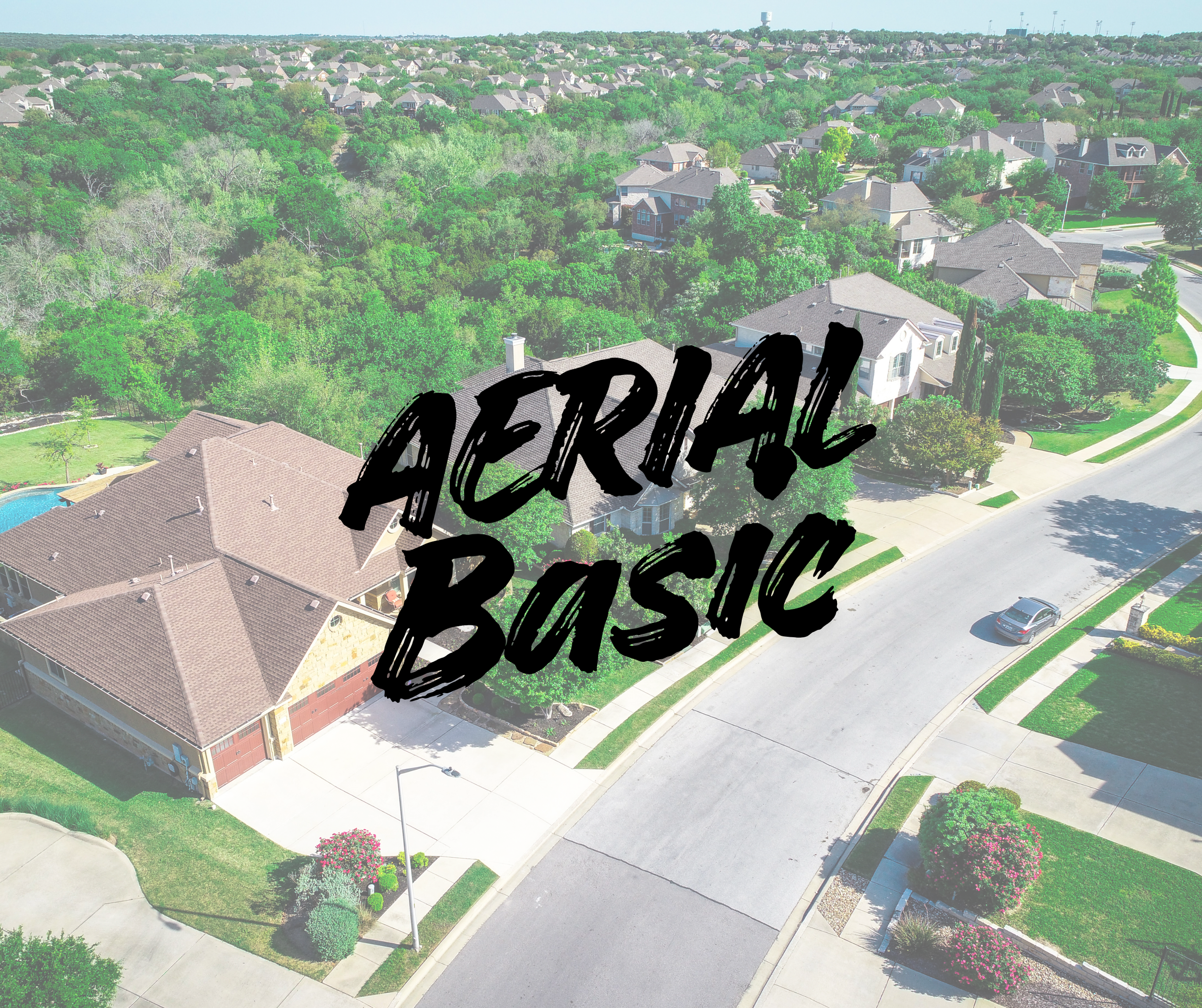 Aerial view of a suburban neighborhood with houses, trees, and streets, overlaid with the text 'Aerial Basic' in bold black font.