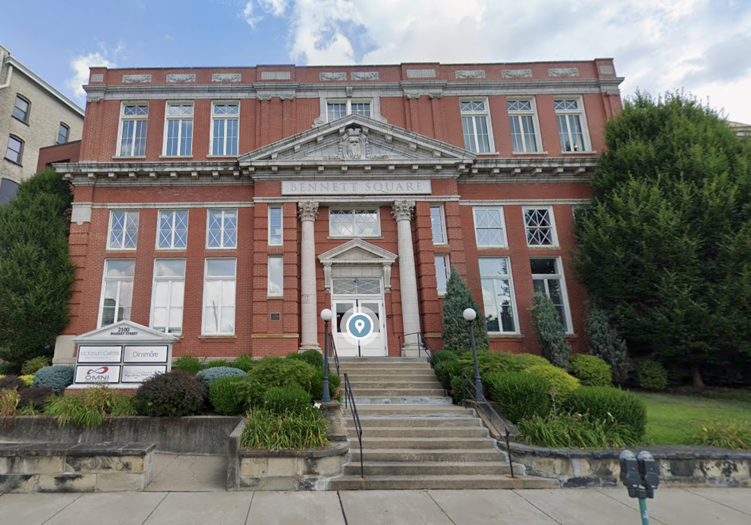 Historic brick building with steps leading to entrance, 