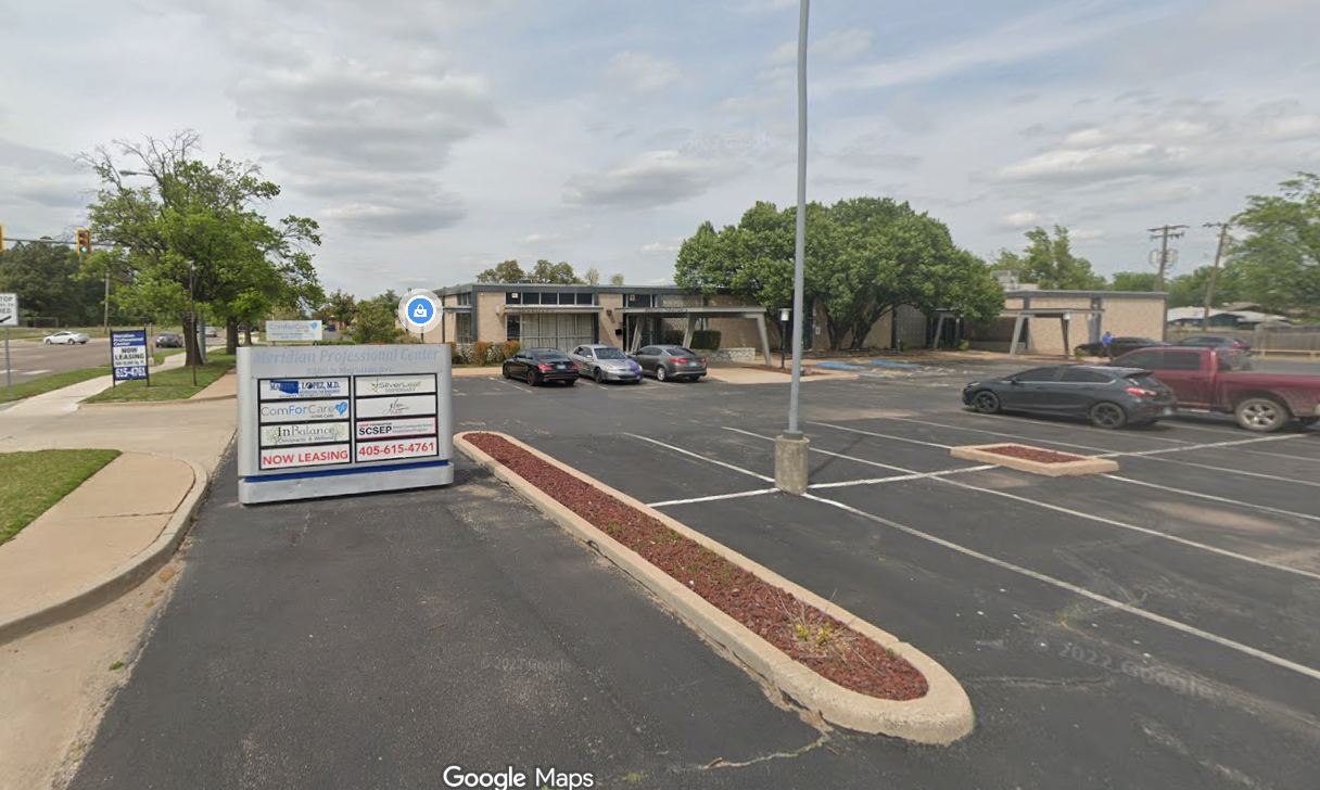 Commercial building with ample parking, covered entrance, and visible entrance.  Handicapped parking available.  