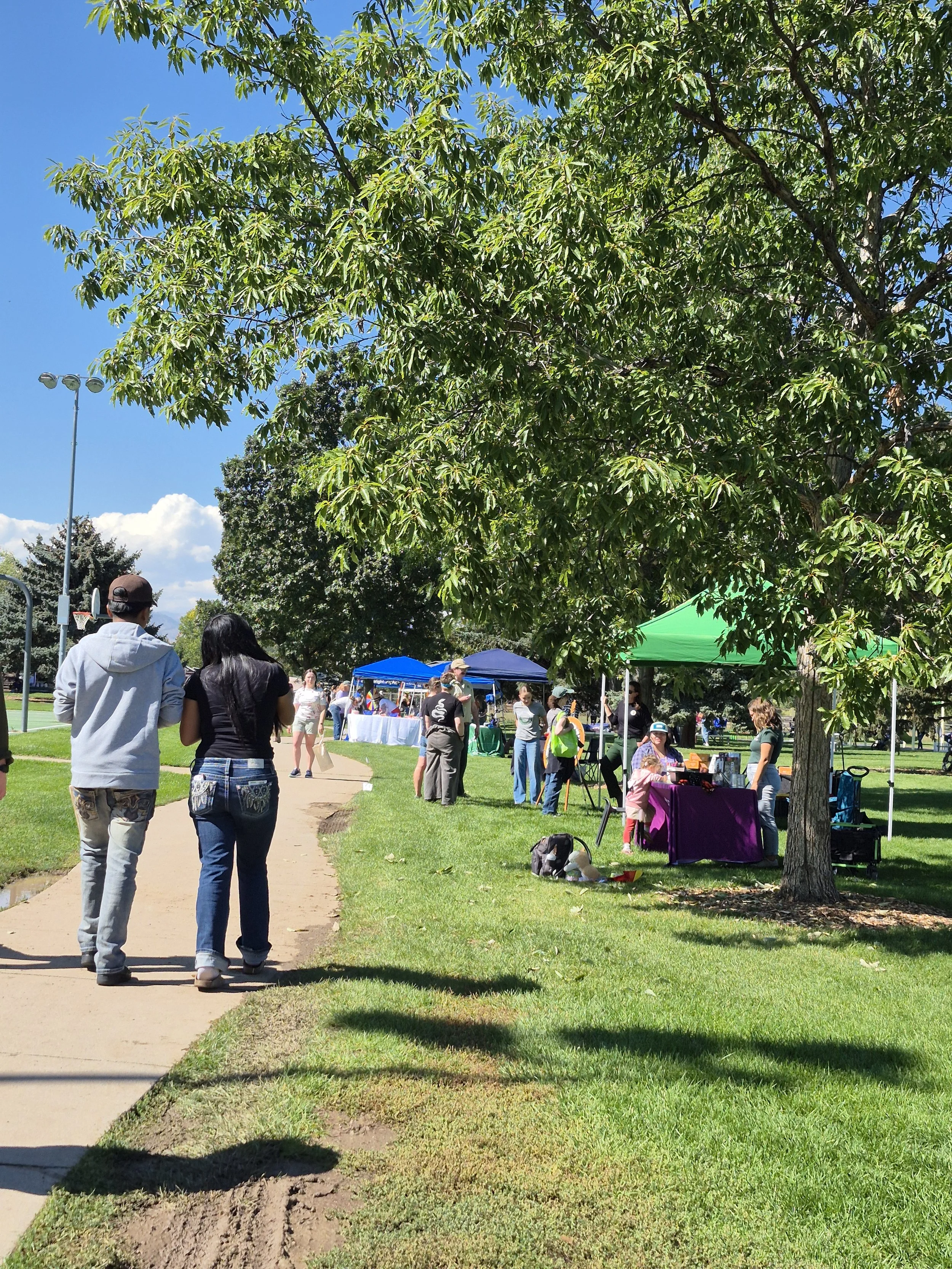 People stroll through Lee Martinez park which is dotted with booths about nature
