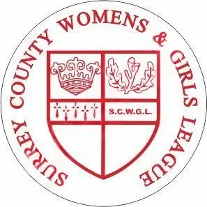 Emblem of Surrey County Women's and Girls League featuring a shield divided into four sections with a crown, a leaf, a row of symbols, and initials S.C.W.G.L, surrounded by the league's name in red circular text.