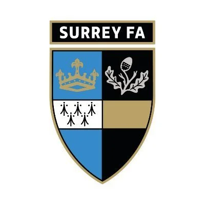 Surrey FA logo with a shield divided into four sections and the text 'Surrey FA' at the top.