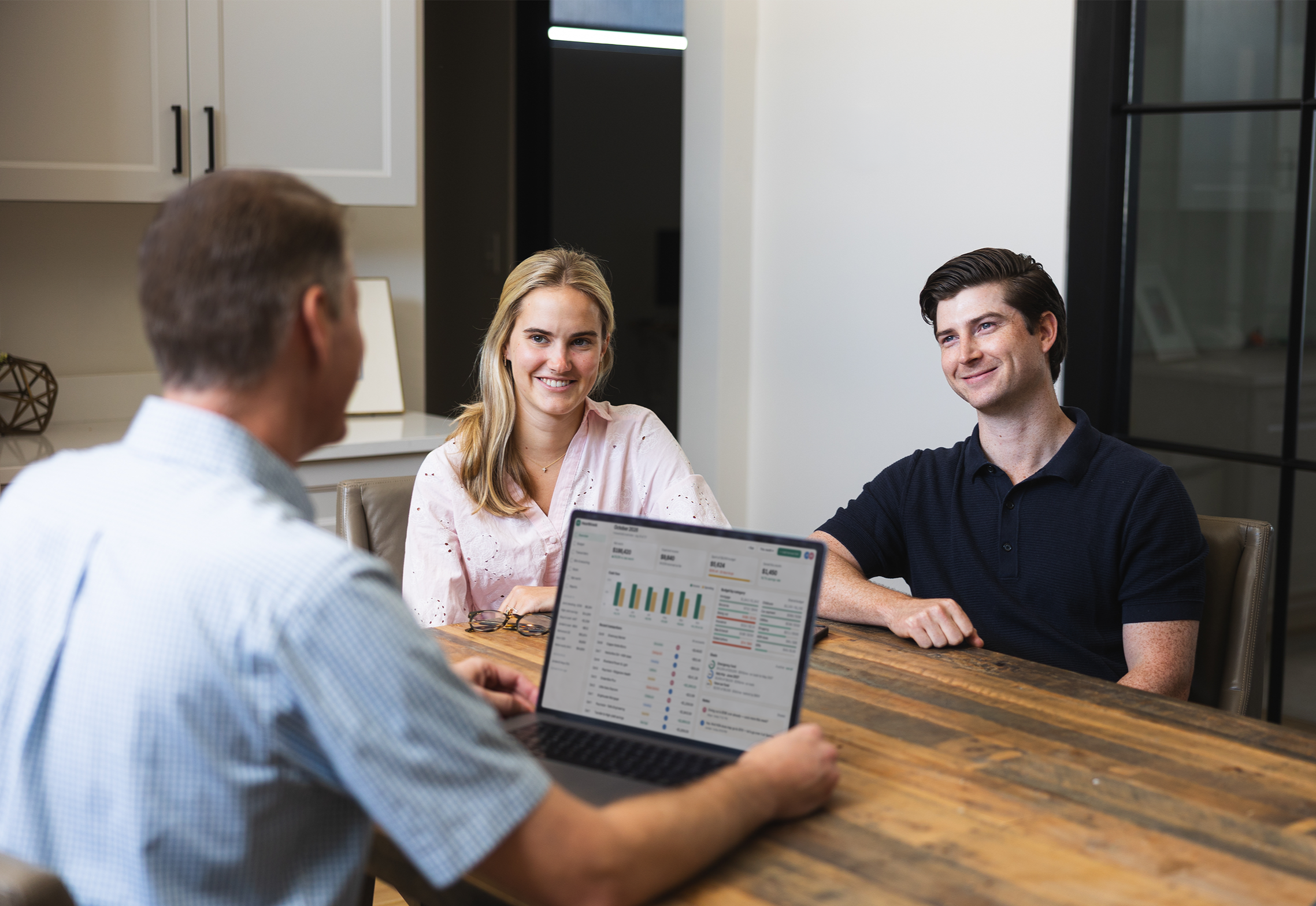 Personal financial consultant with Omnalytics discussing budgeting with a couple.